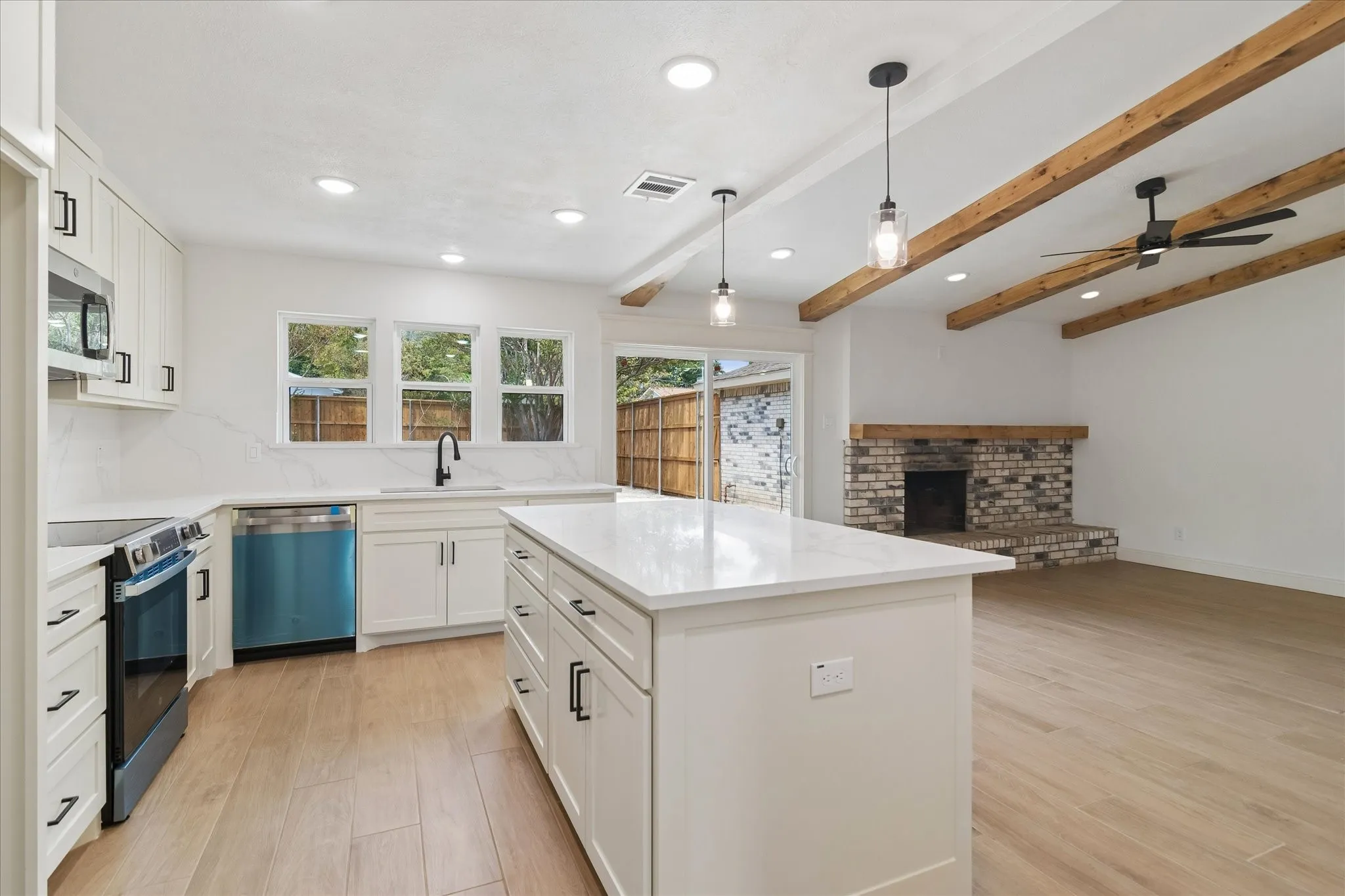 Custom kitchen with quartz counters and matching backsplash