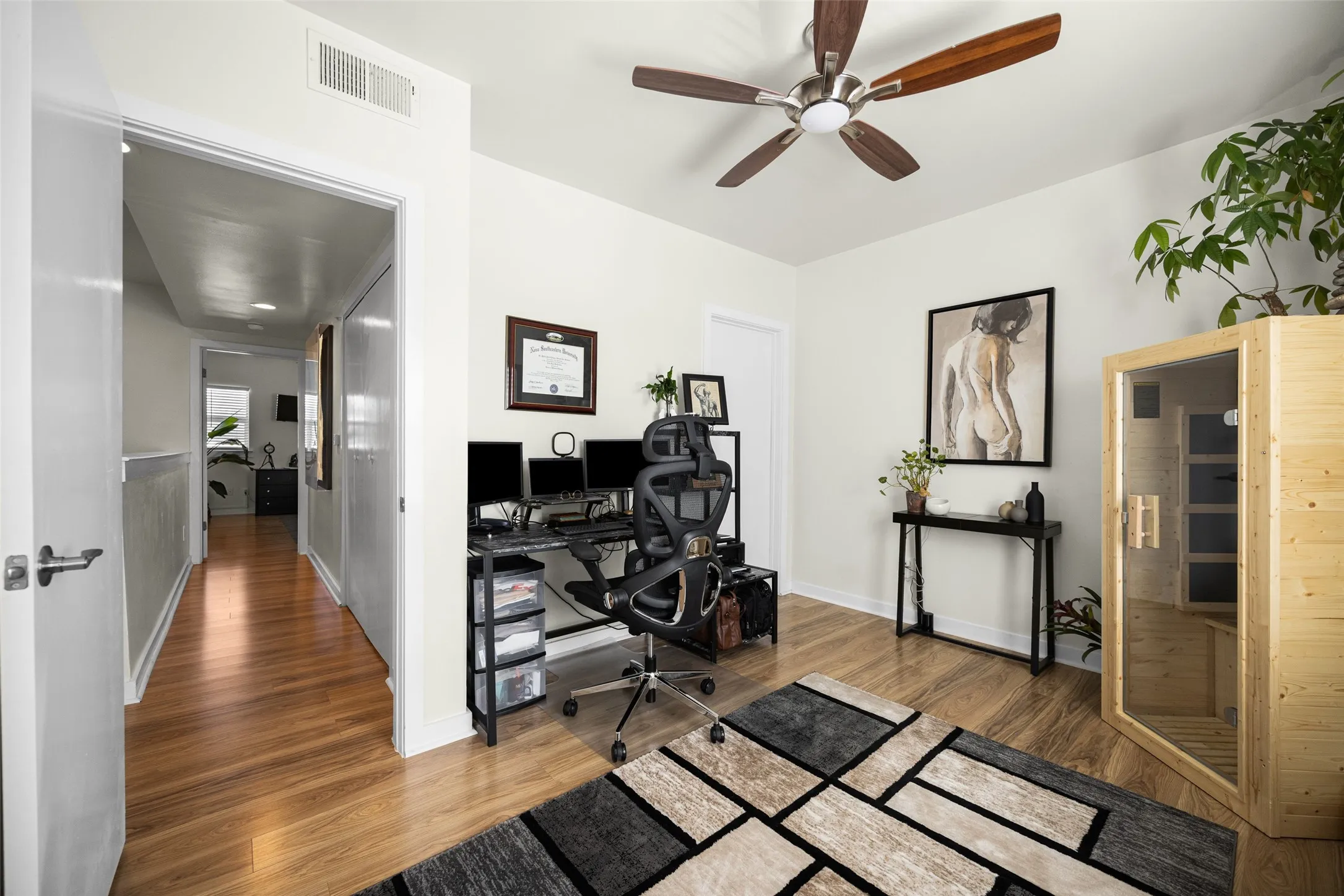 Light wood-finish flooring complements neutral wall tones