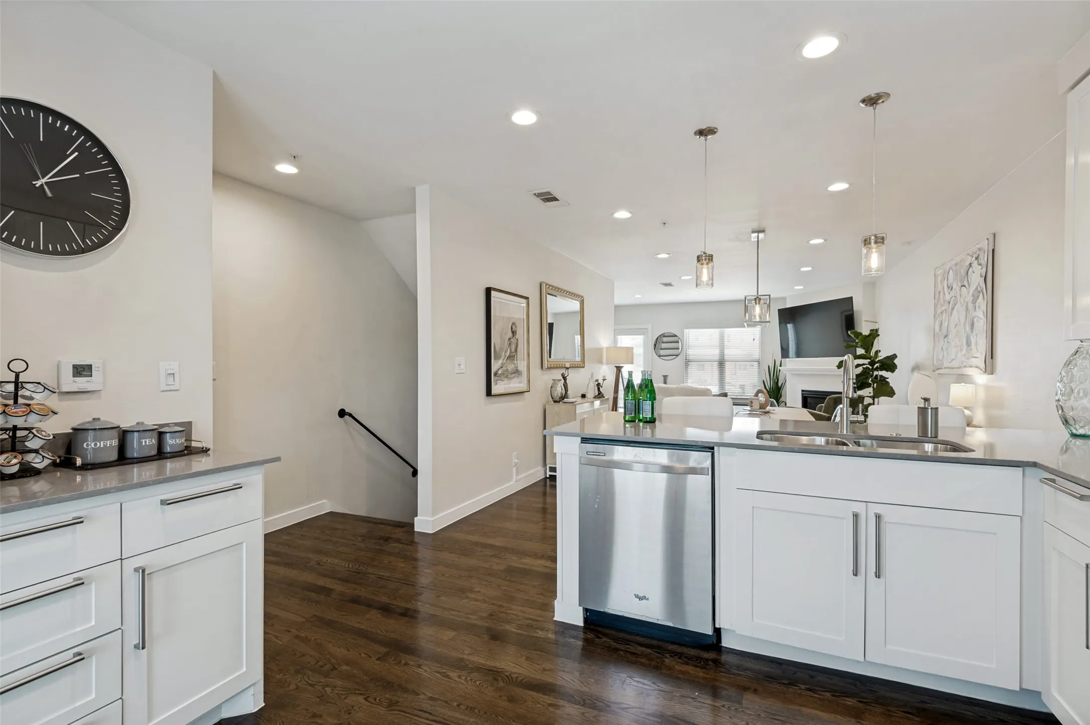 Kitchen featuring white cabinetry, gray countertop, stainless steel dishwasher, and recessed lighting