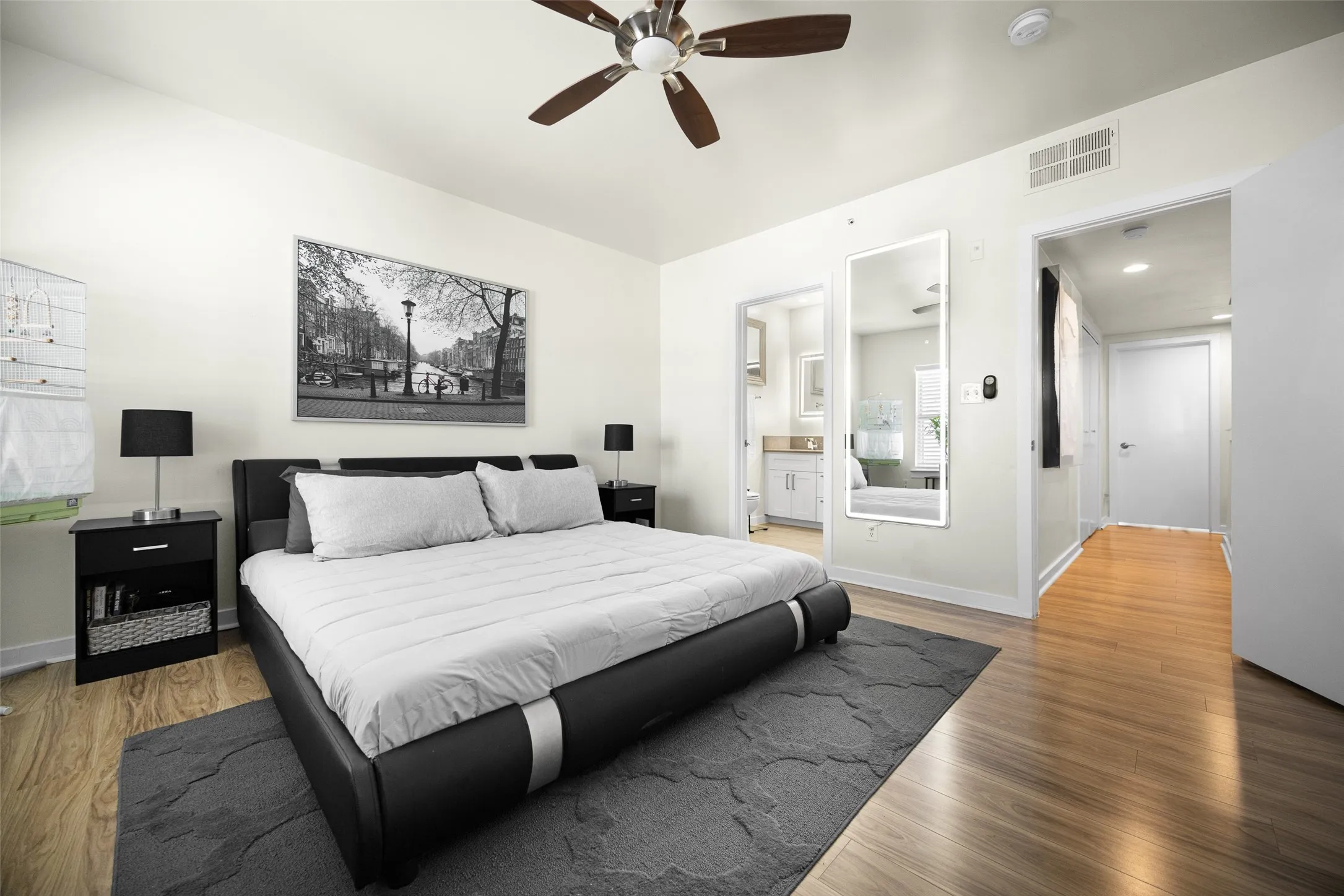 Spacious room featuring wood-finish flooring, a ceiling fan, and recessed lighting