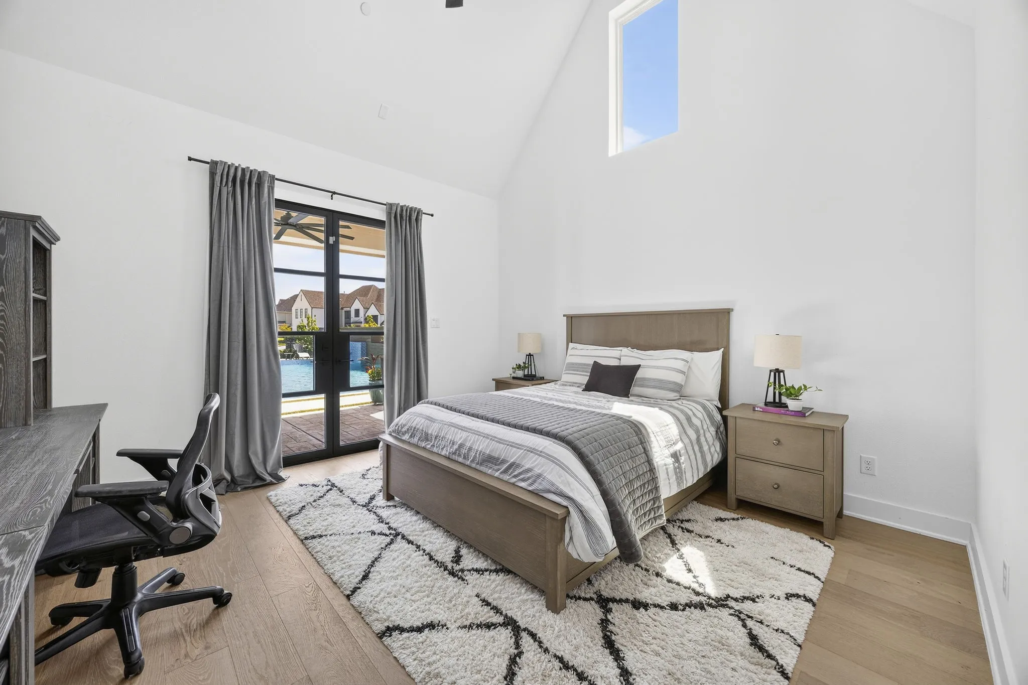 Downstairs guest suite opens to the pool with a covered patio and has a large walk in closet and bathroom. Would make an excellent in-law suite.
