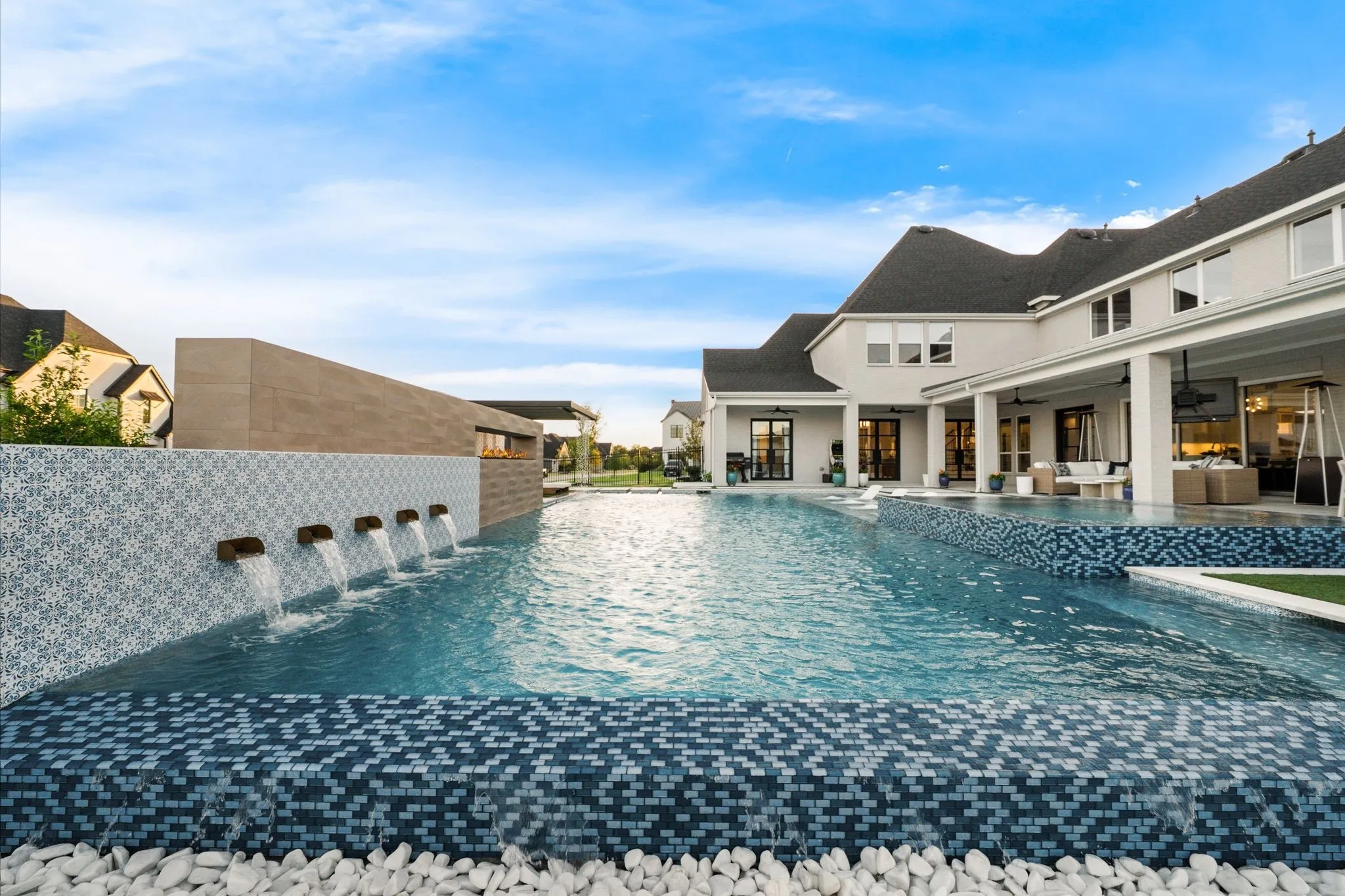 50 Ft pool features a HUGE spa, 5 scupper water features, a fireplace, and a rain curtain cabana