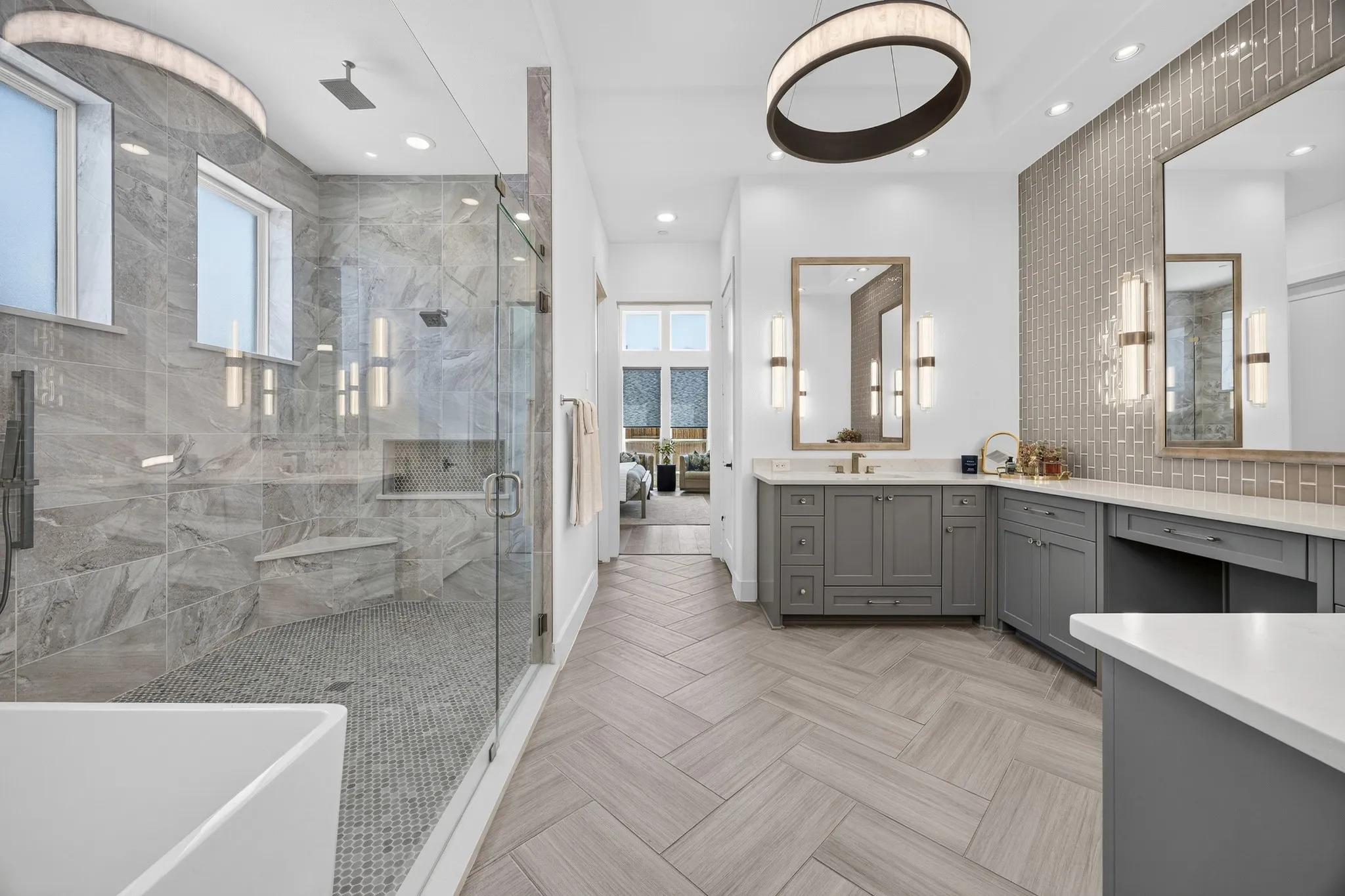 Primary bath features a wet room with a deep soaking tub and shower with dual shower heads, one hand held, and one rain shower head.
