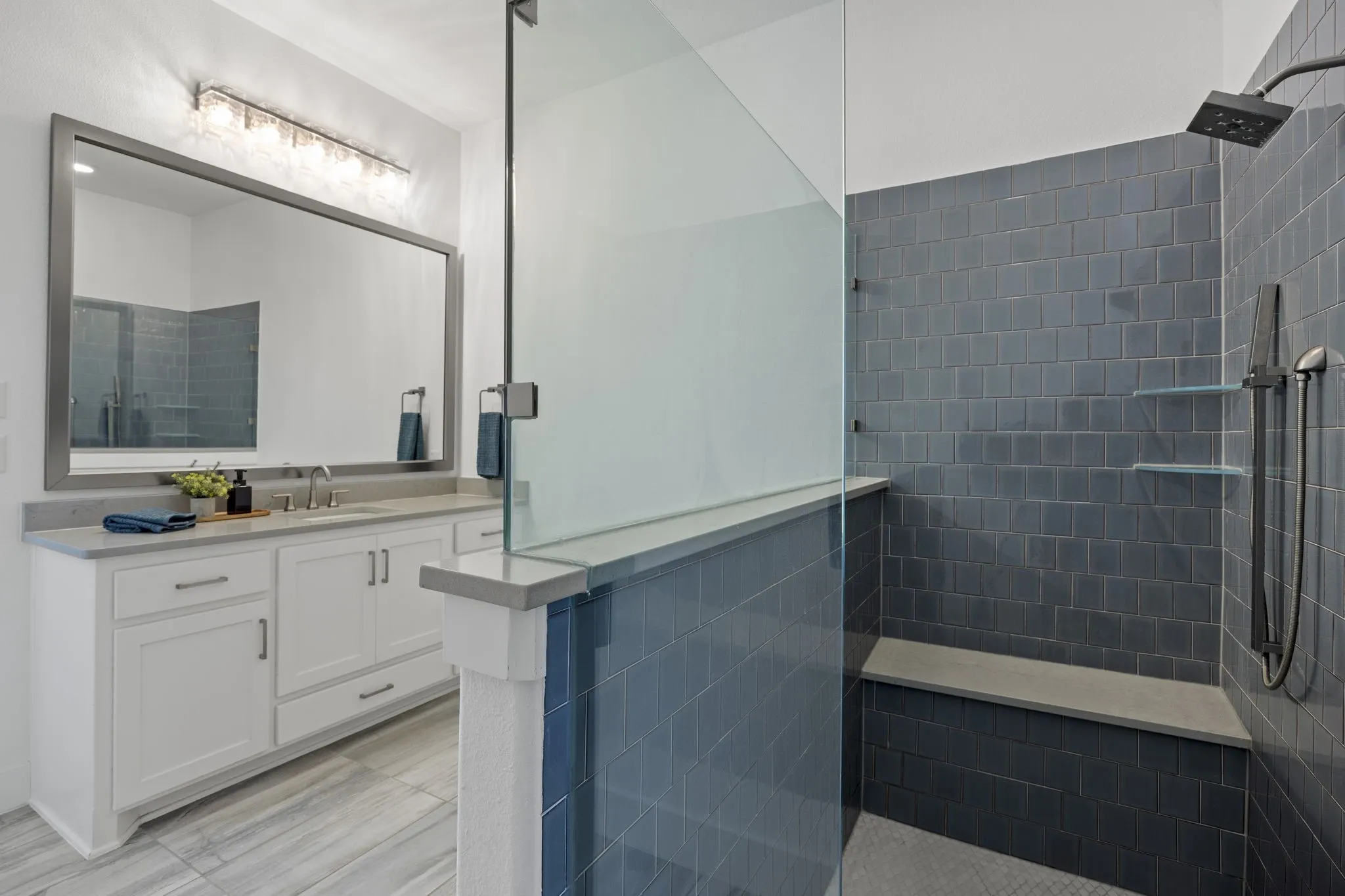 Ensuite bath has an additional handheld shower head and bench.