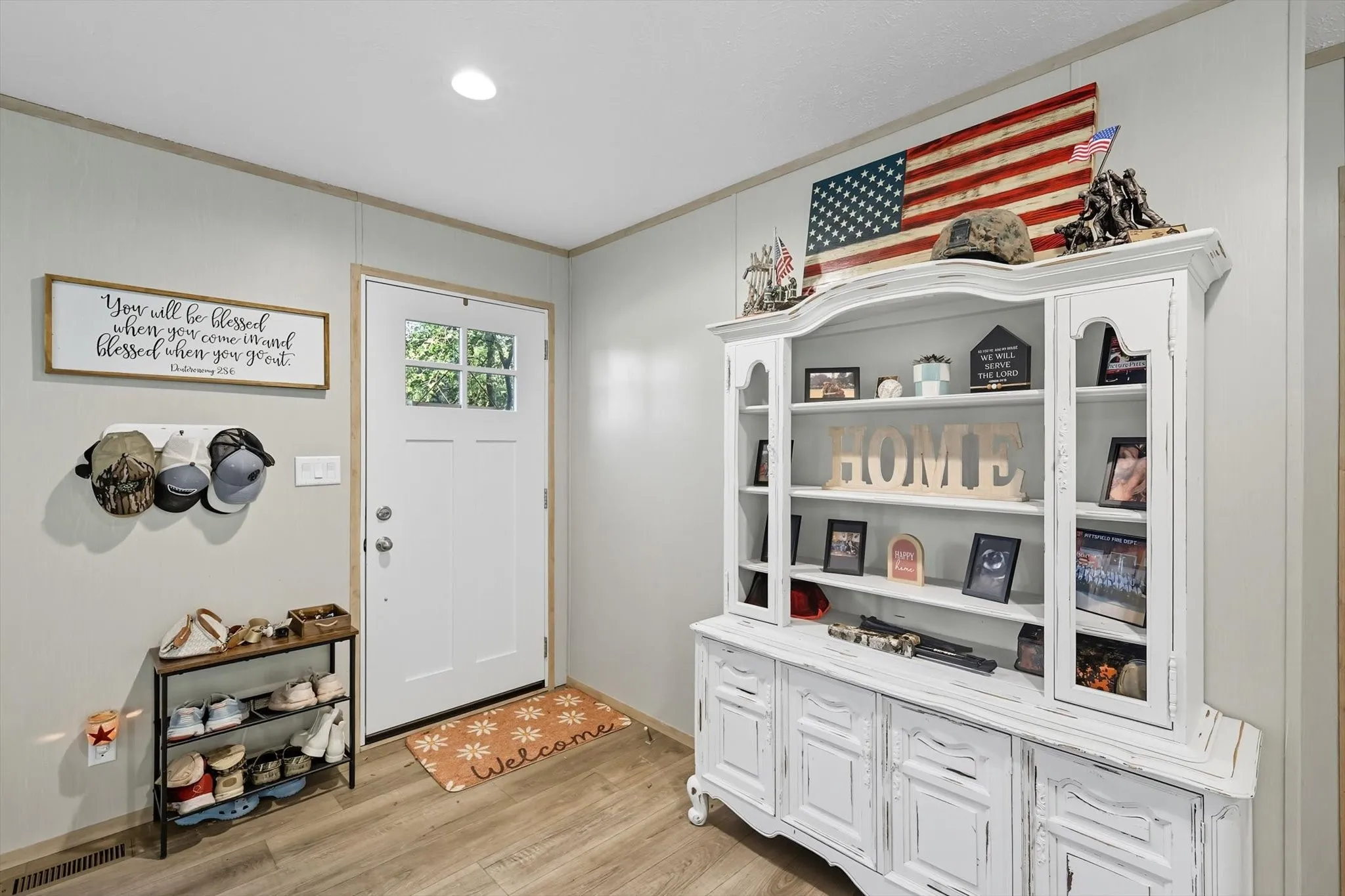 Foyer with crown molding, light wood-style flooring, and recessed lighting