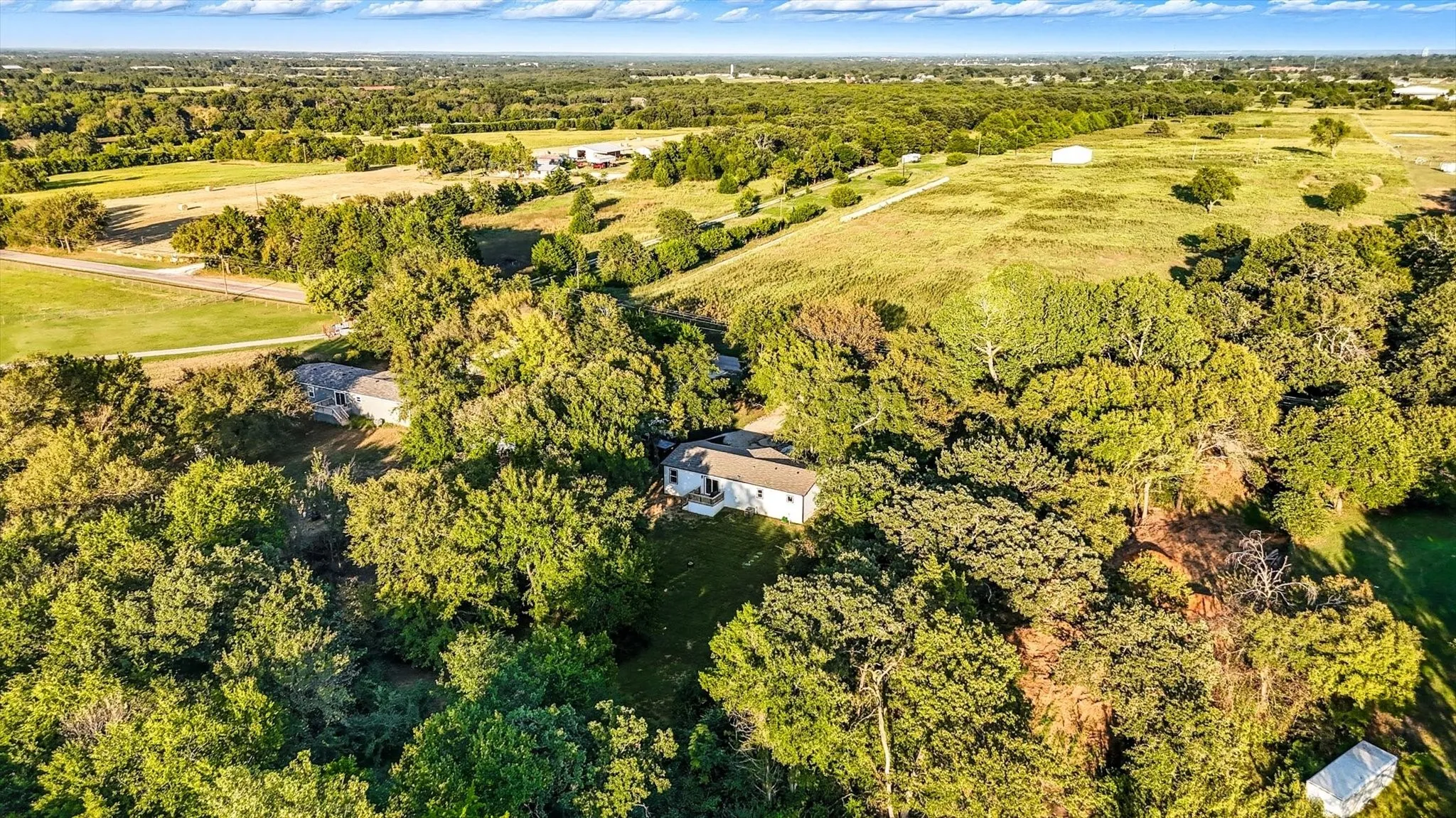Aerial view of property's location featuring a forest