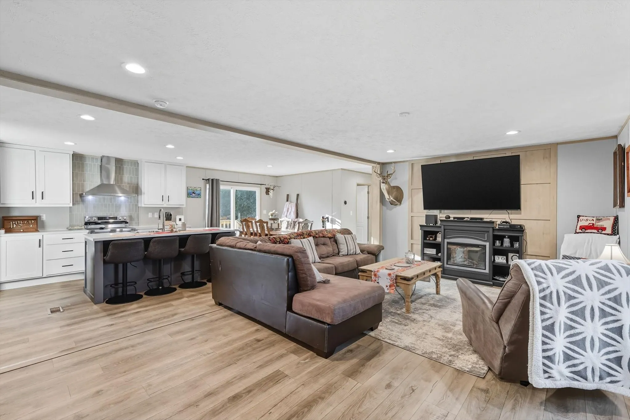 Living area with recessed lighting and light wood finished floors