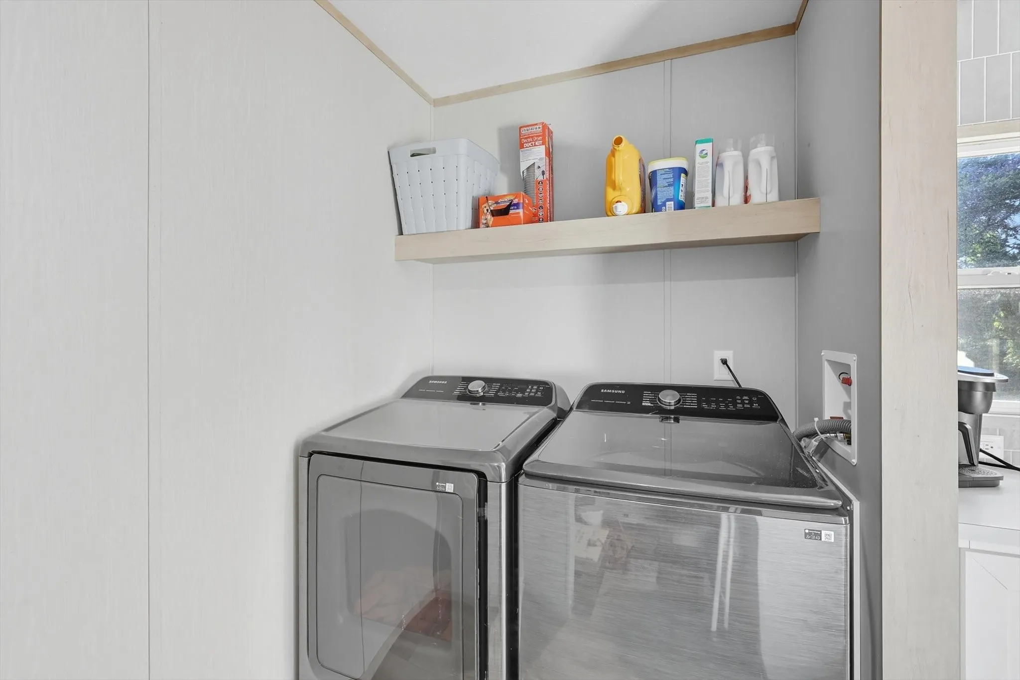 Washroom with washer and dryer and crown molding