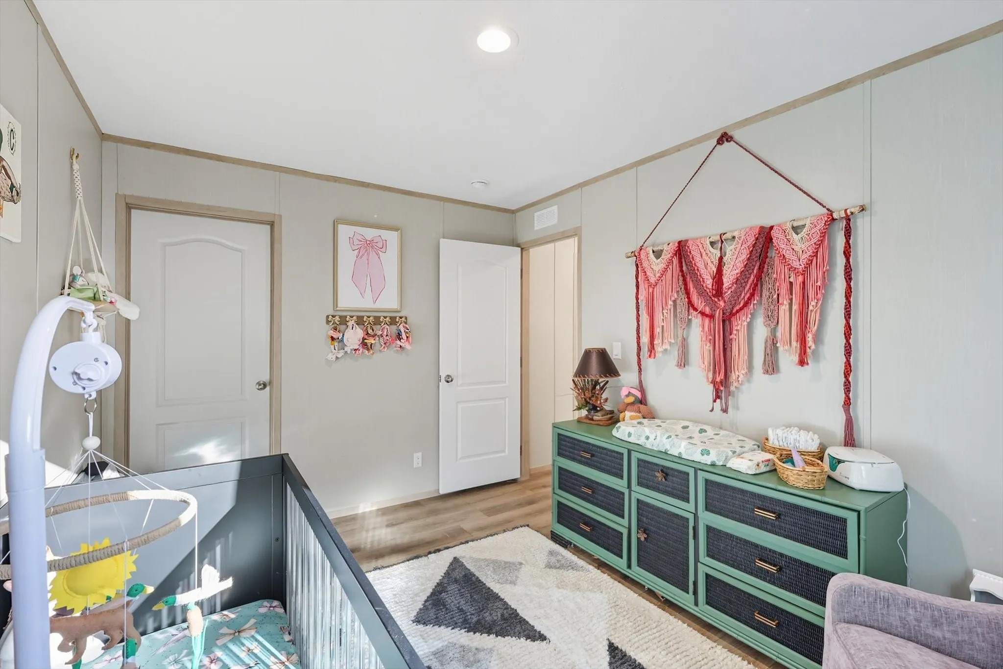 Bedroom featuring wood finished floors, recessed lighting, a closet, and ornamental molding
