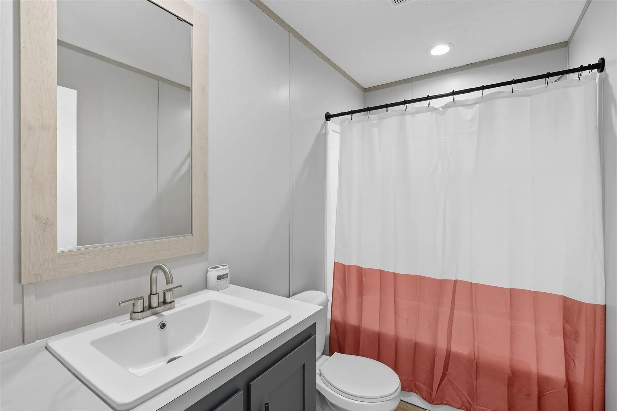 Full bathroom with vanity and recessed lighting