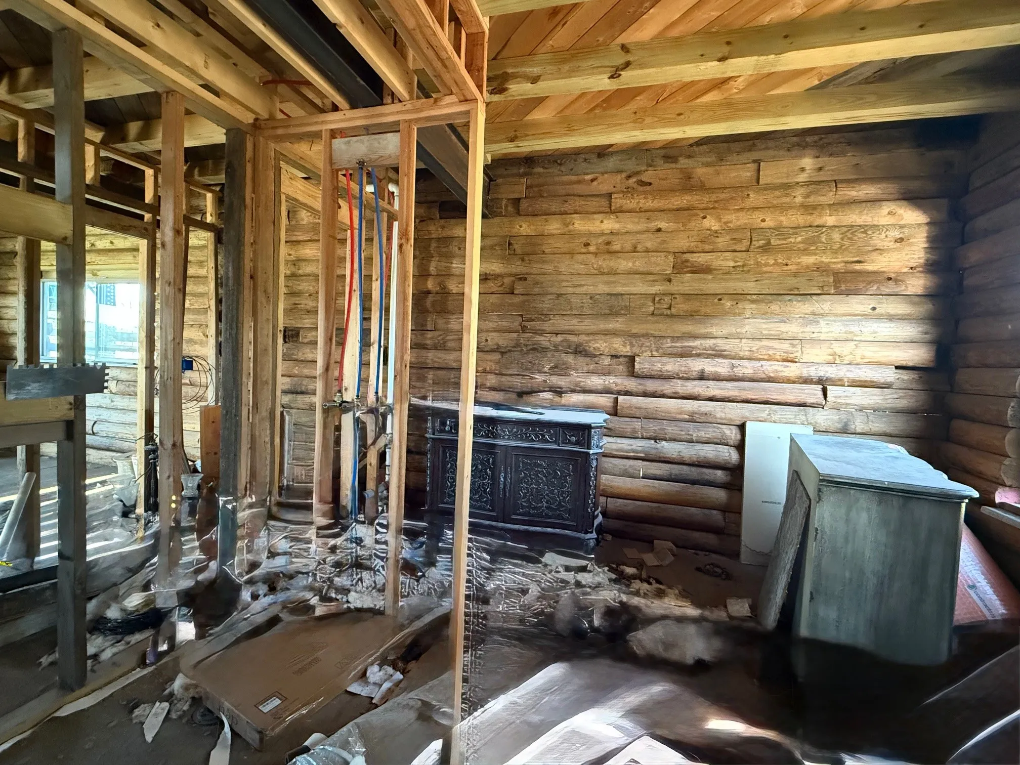 Interior space featuring natural wood log walls and exposed wood framing