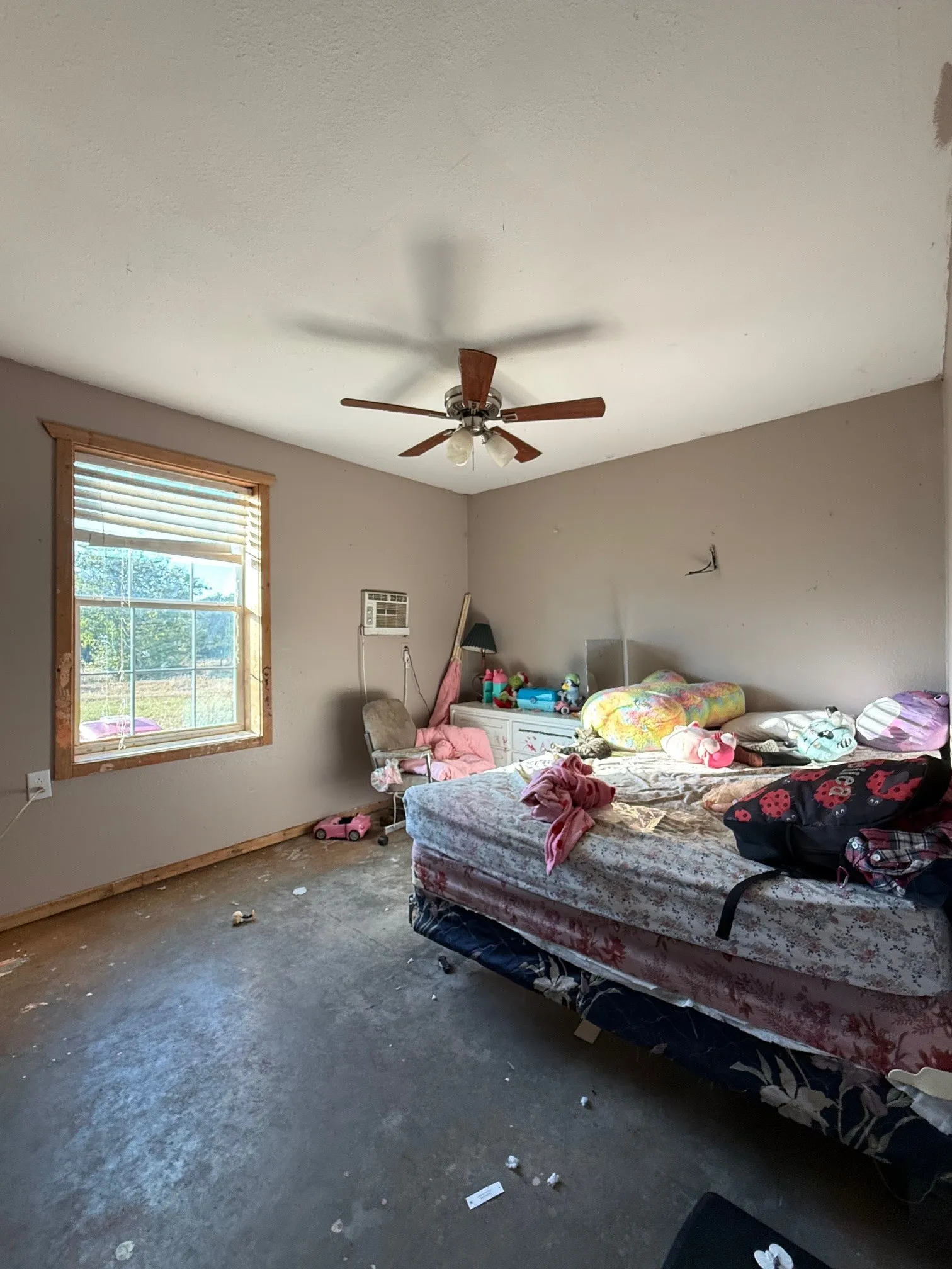 Interior room with a window featuring natural wood trim and blinds