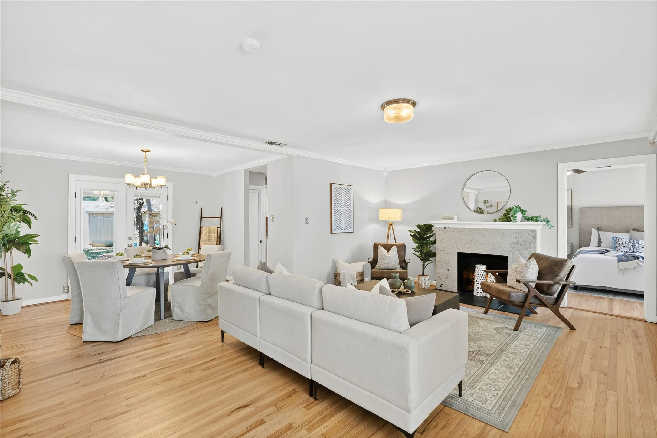 Hardwood flooring throughout, recessed lighting, and crown molding