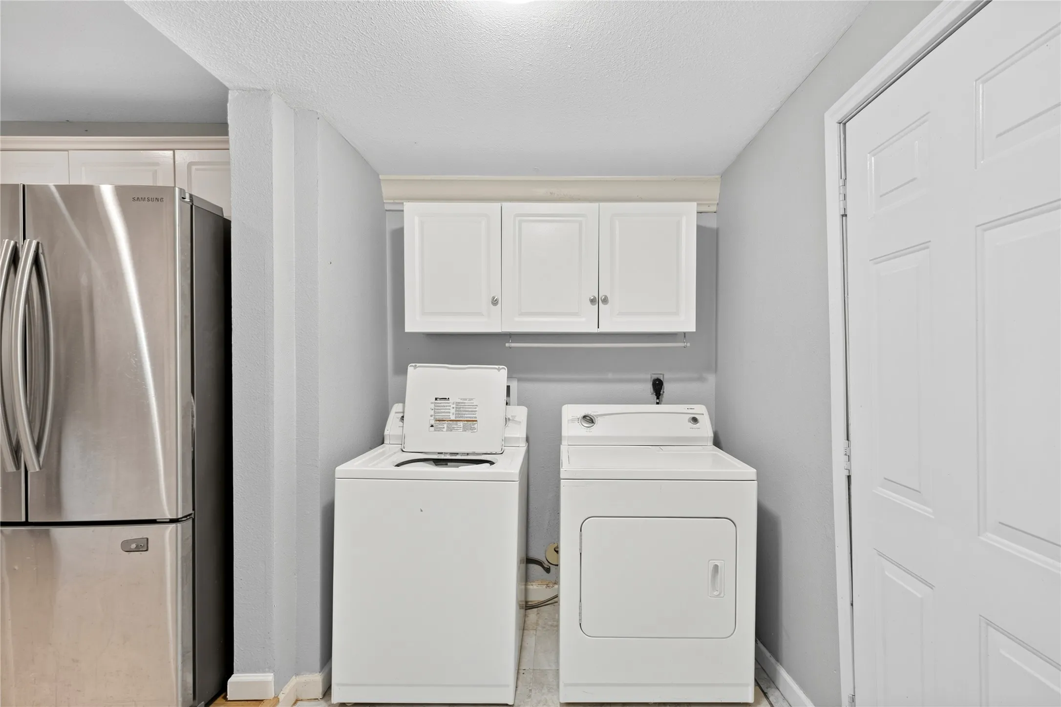 White cabinetry and light-toned walls