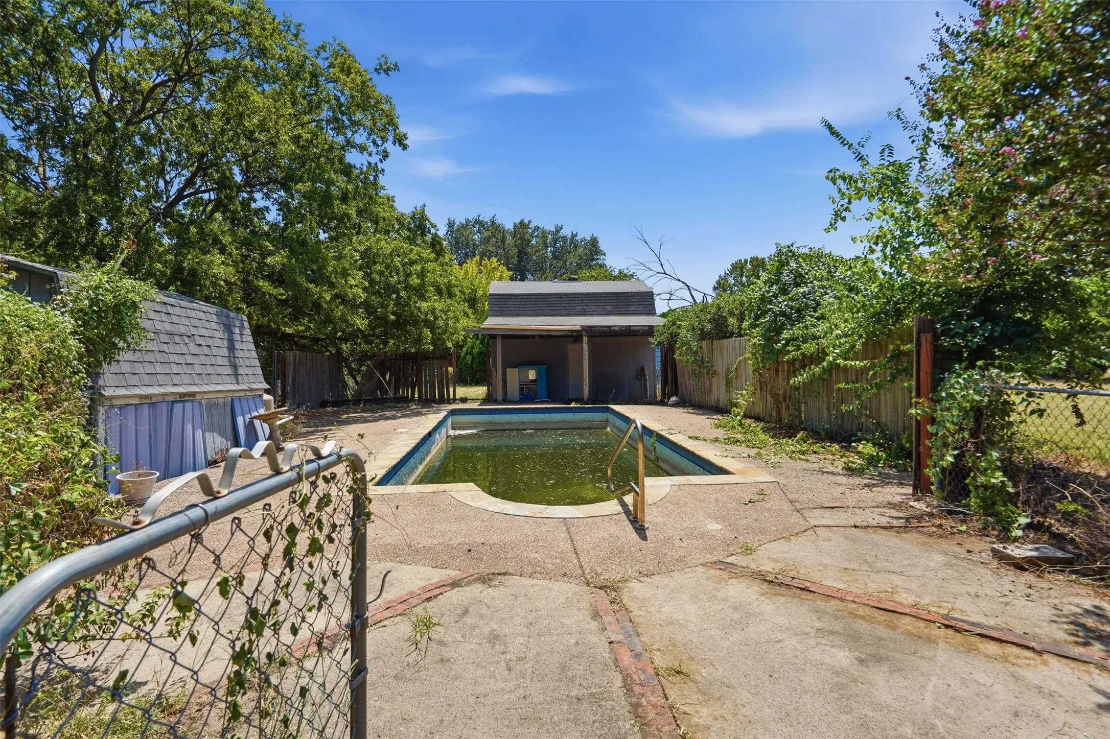 In-ground swimming pool with concrete surround