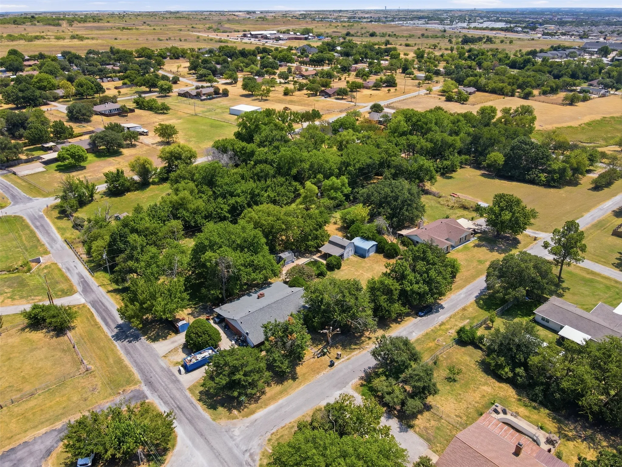 Expansive property featuring mature trees and a residential street