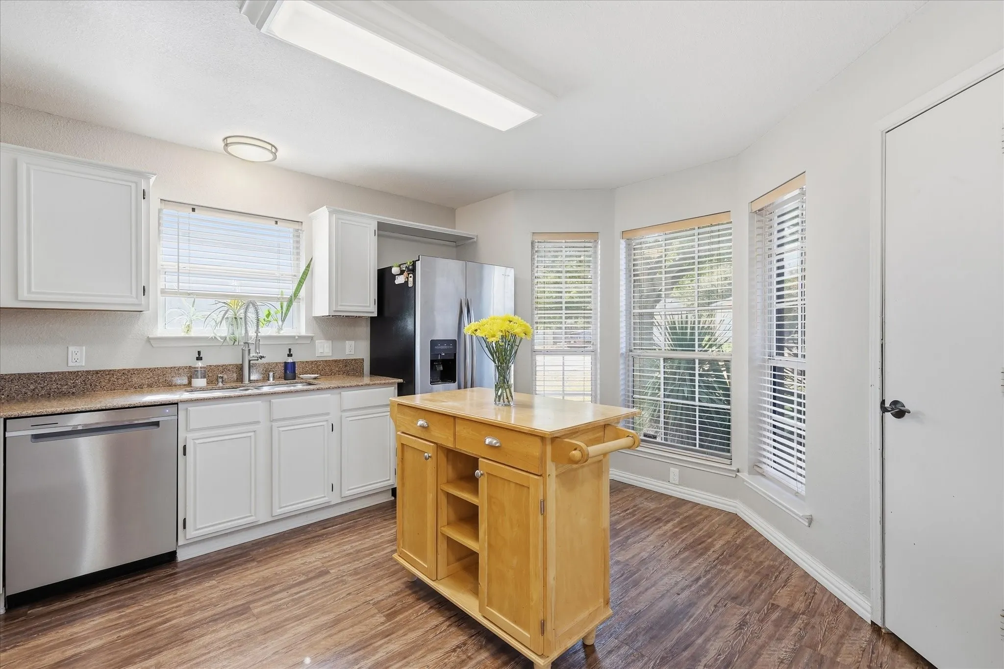 Kitchen has a bay window that looks out over front yard.
