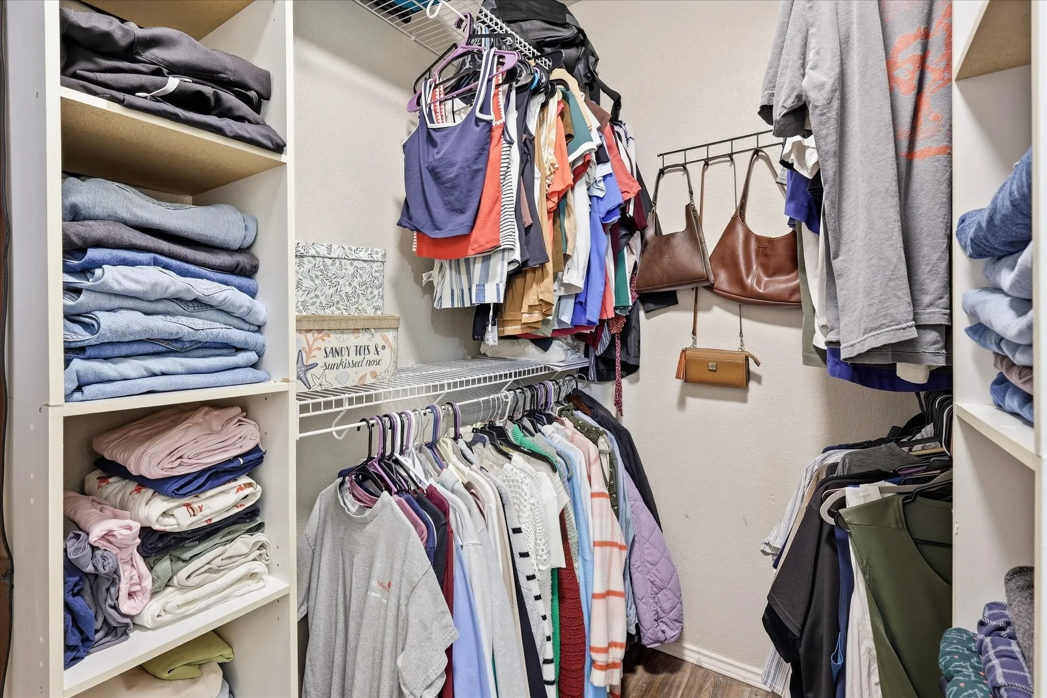 Nice walk-in primary closet with built in shelves.