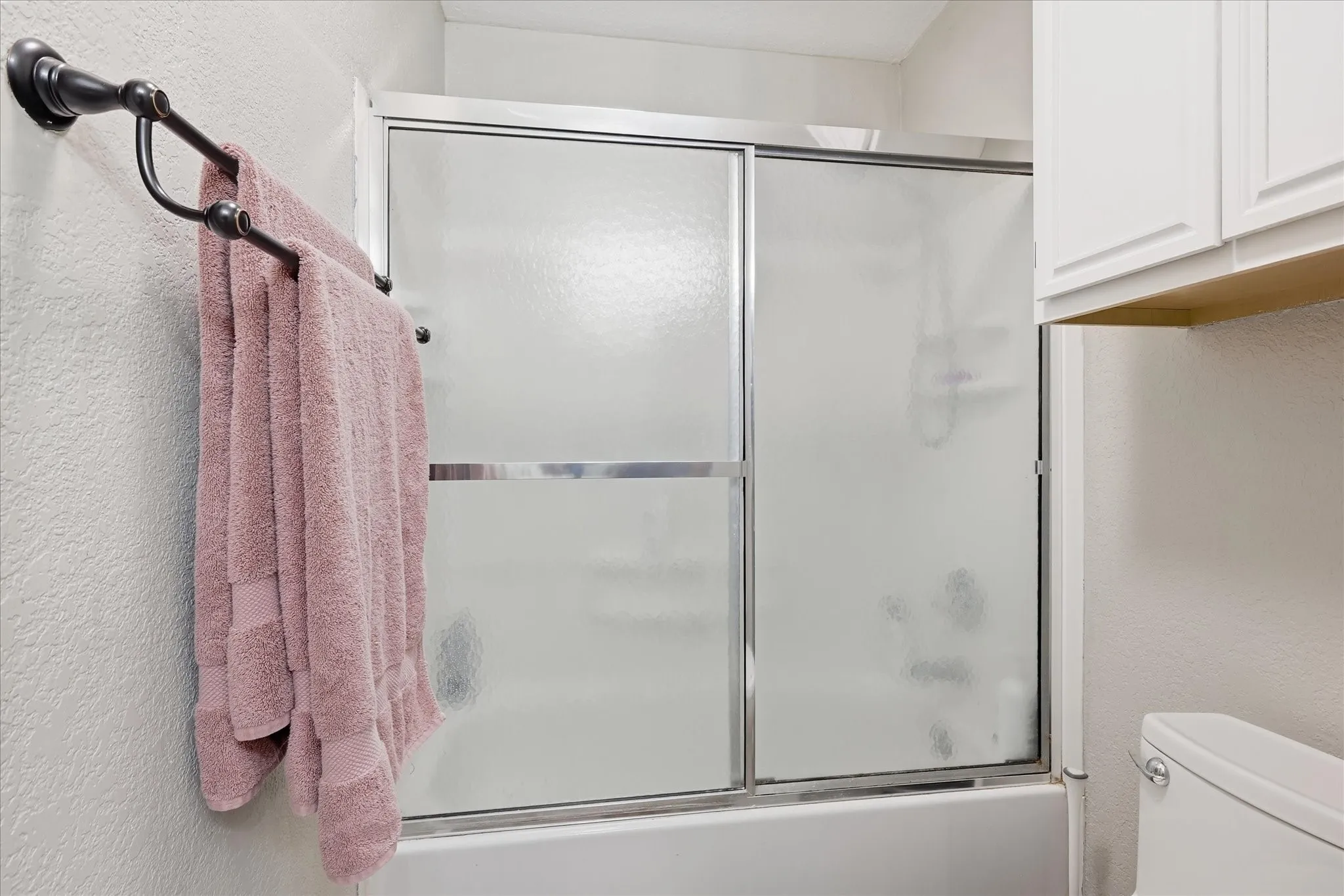 Tub shower combo with privacy glass. Extra cabinet storage as well!