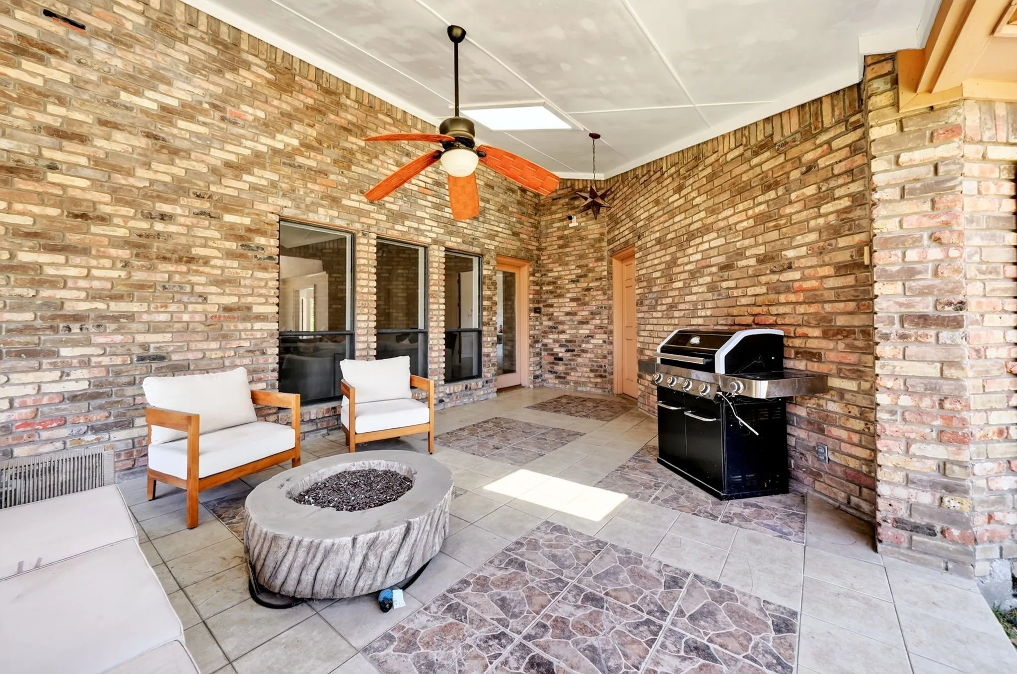 Covered patio with brick walls, recessed lighting, and ceiling fans