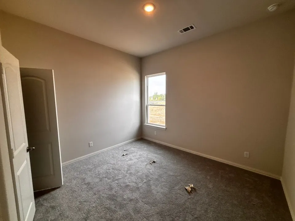 Neutral-toned walls complement plush carpeting