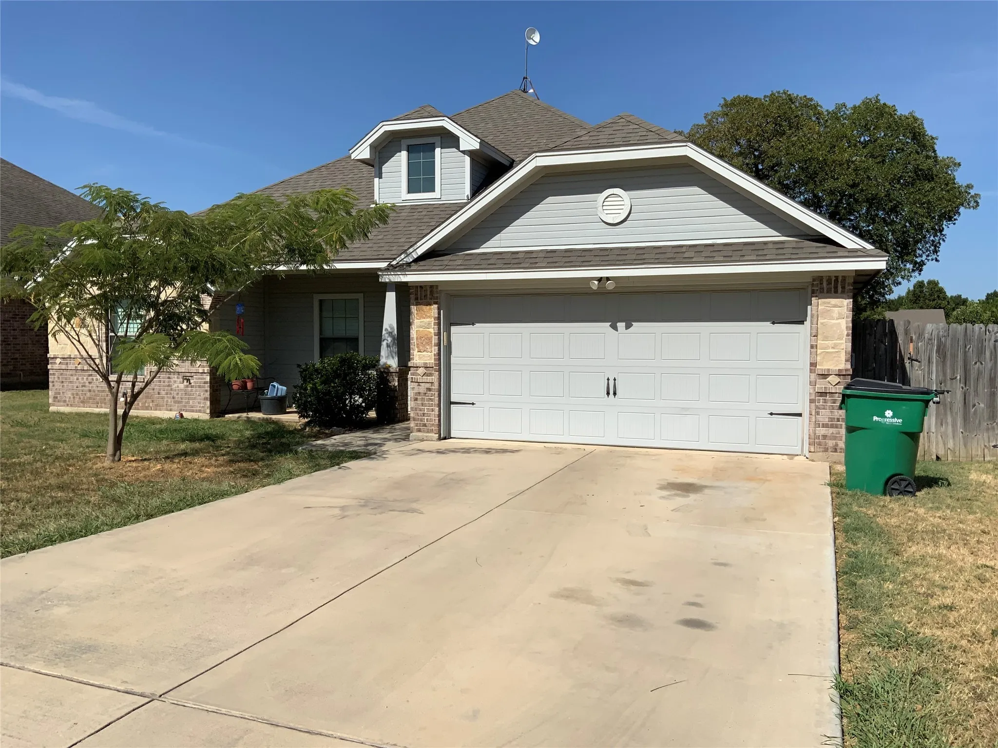 Concrete driveway leading to a two-car garage with decorative hardware