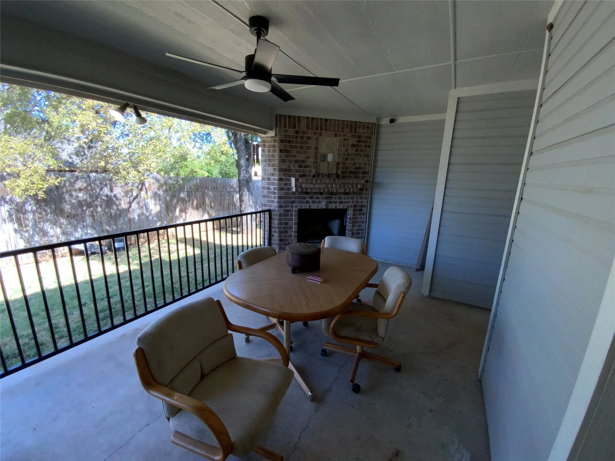 Covered patio with a ceiling fan, recessed lighting, and a brick fireplace