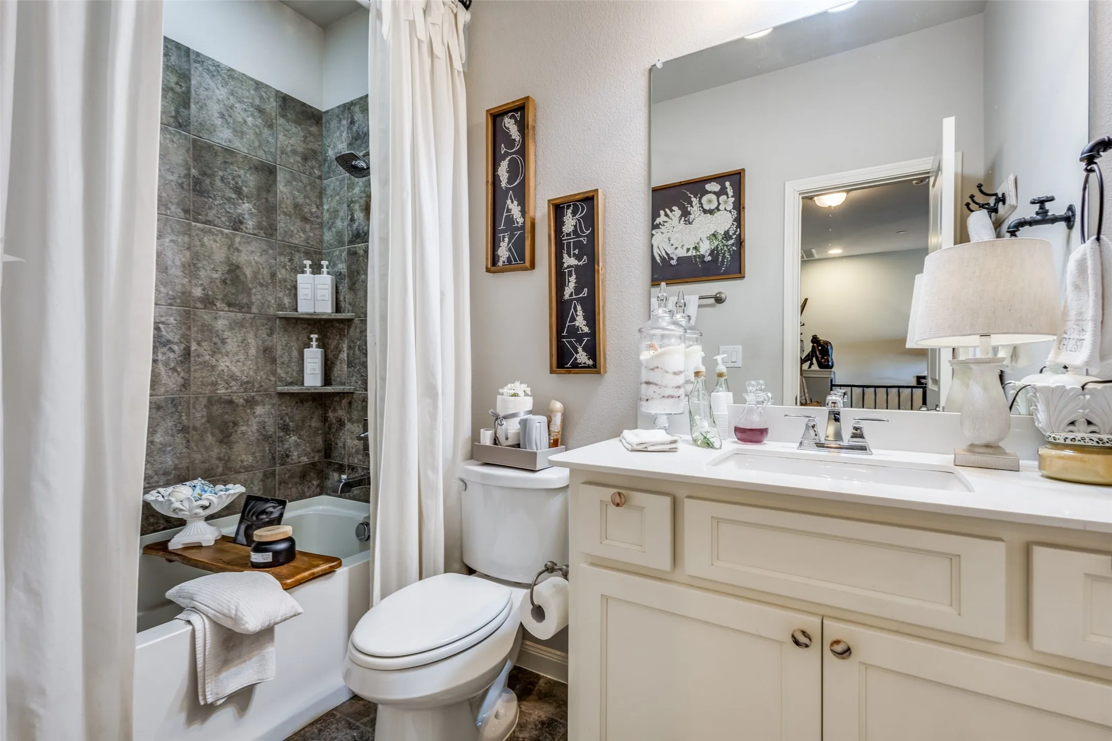 White vanity with integrated sink, chrome faucet, and rectangular mirror