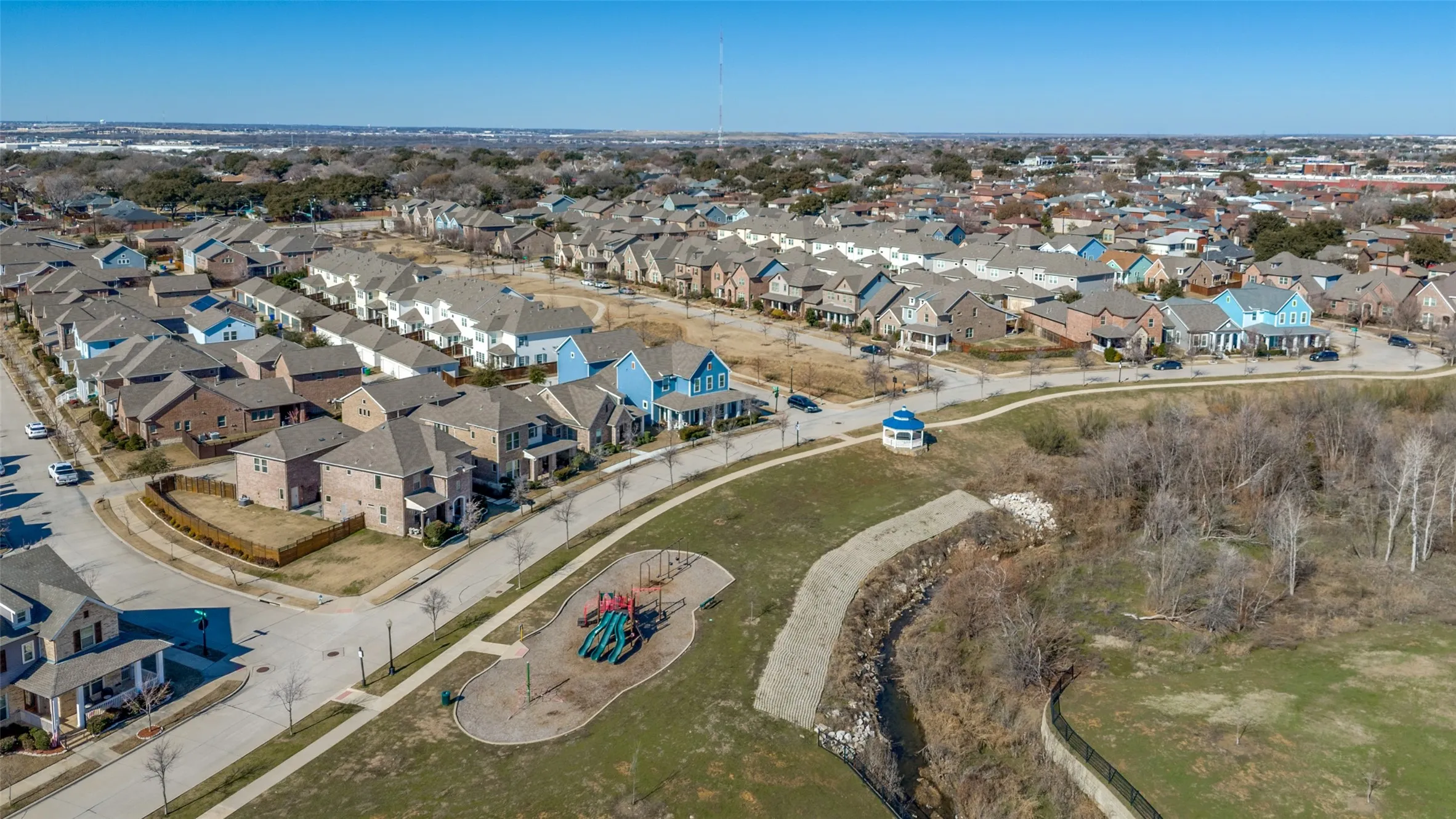 Established community with a central playground, paved walking paths, and varied architectural styles
