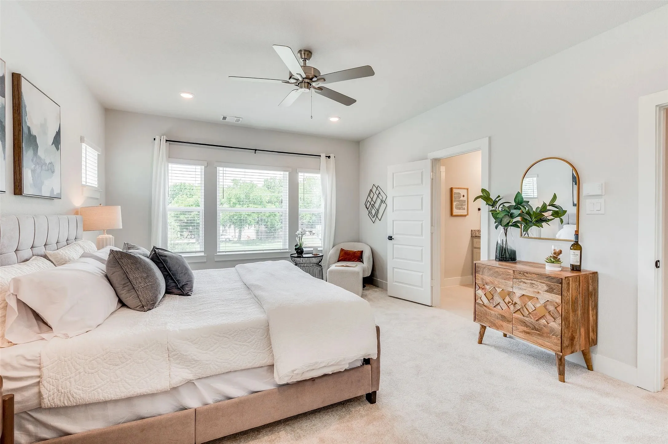 Recessed lighting, ceiling fan, large windows with white blinds, light-toned carpeting, and a white paneled door