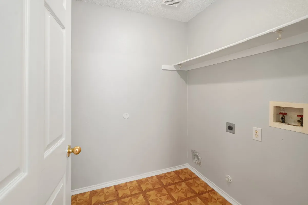 Utility room big enough for full size washer and dryer and has shelving to keep you organized