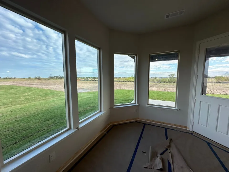 Bay window configuration with multiple large windows and a glass-paneled door