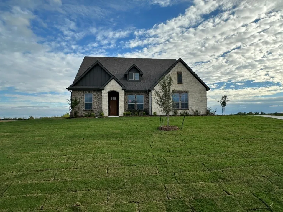 Stone and brick exterior with dark trim accents