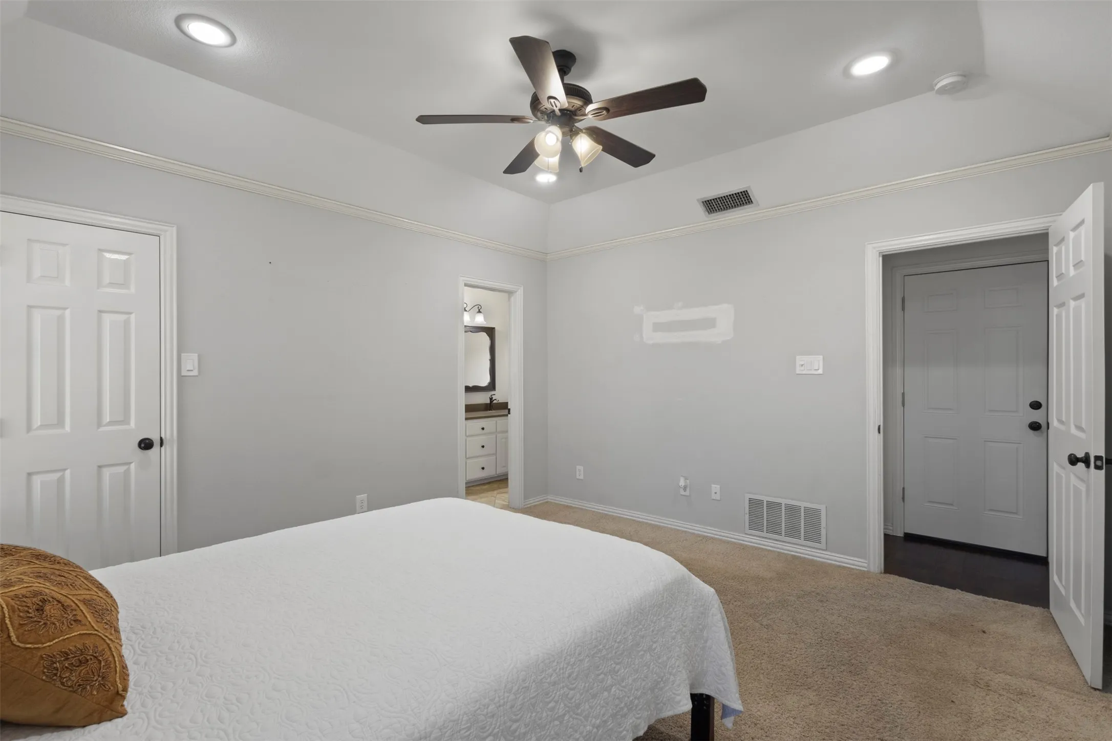 Tray ceiling with recessed lighting and crown molding
