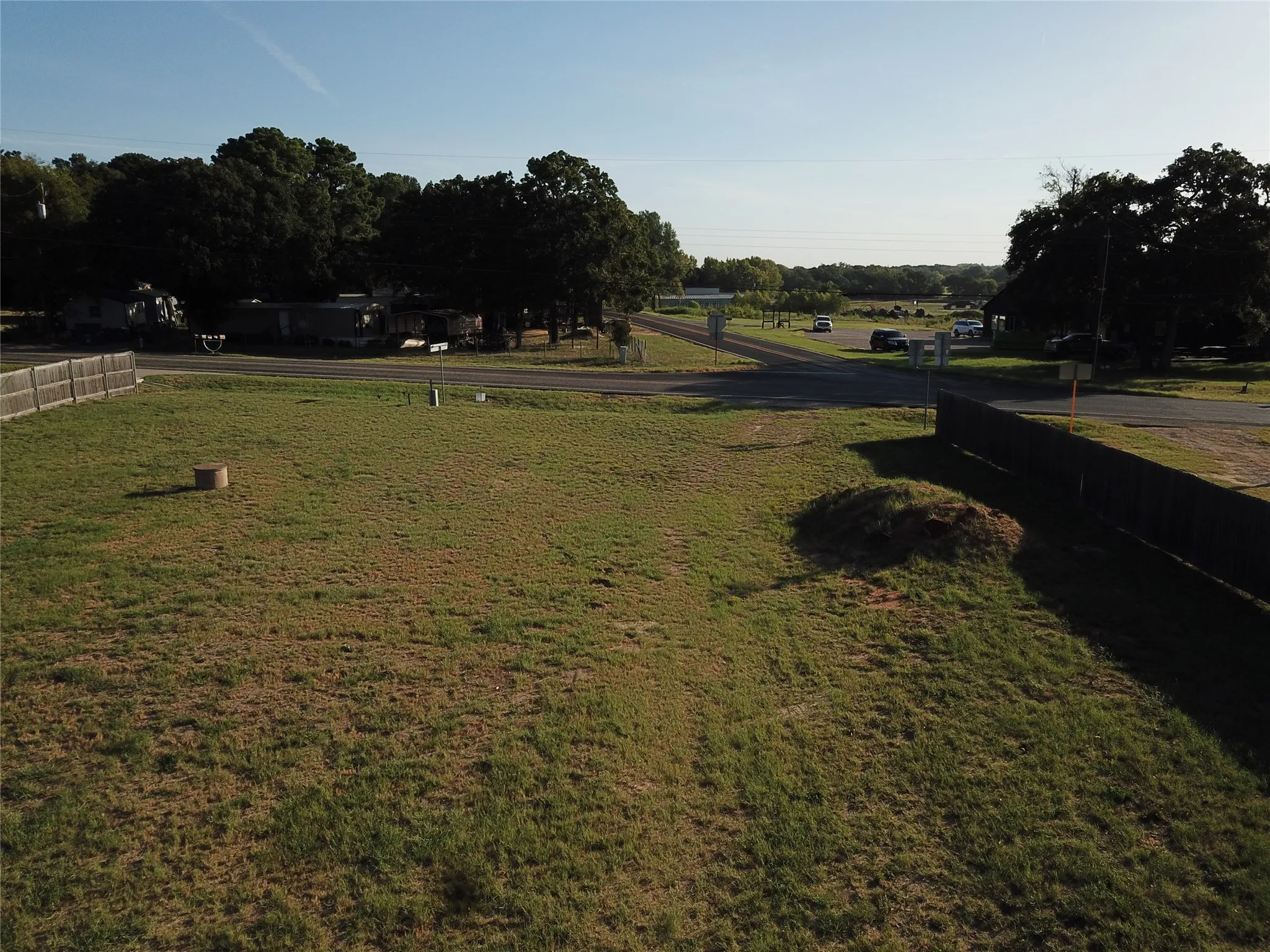 Expansive grass lot with a wood privacy fence