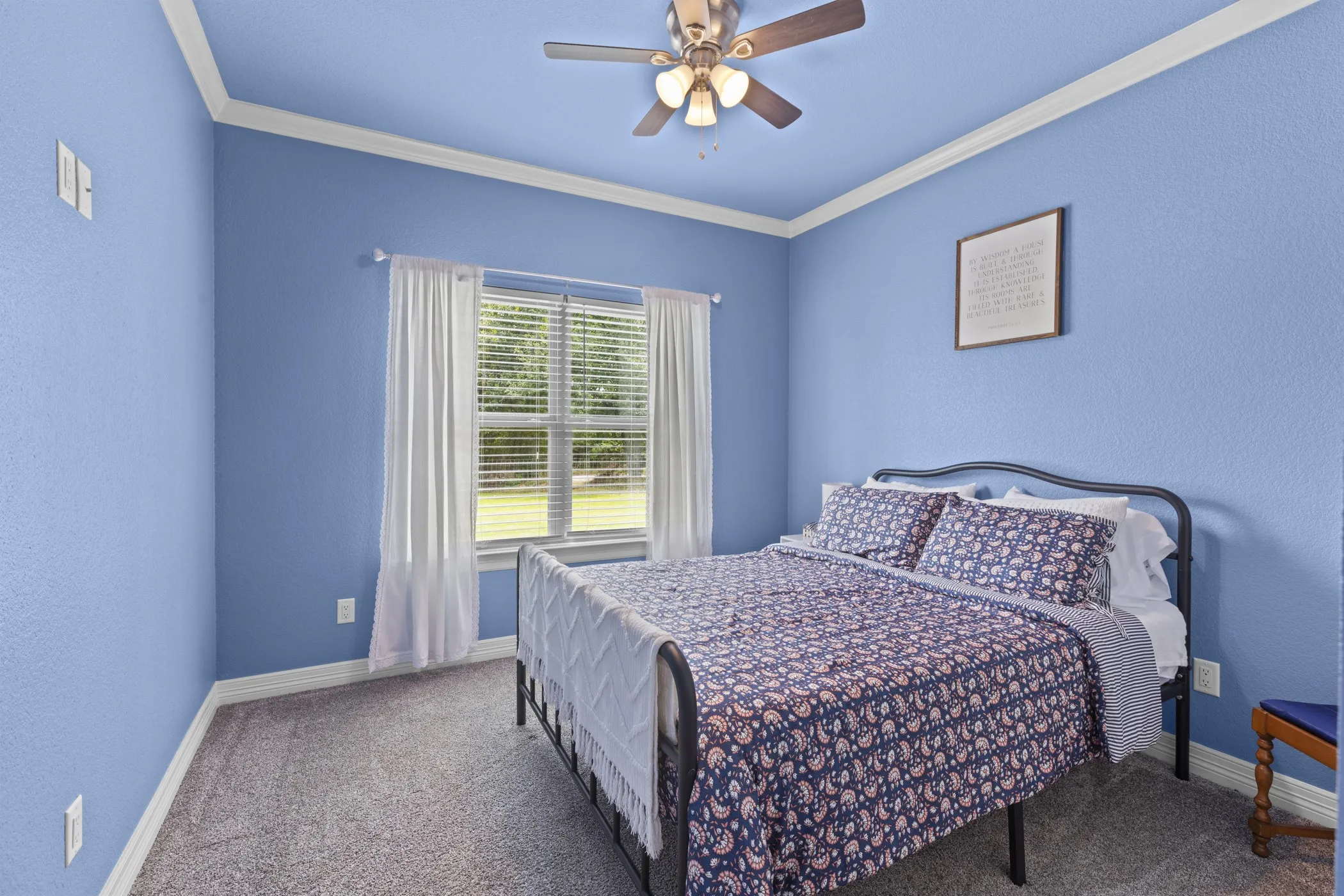 Textured walls with crown molding, ceiling fan with integrated lighting, window with blinds, and neutral carpet flooring