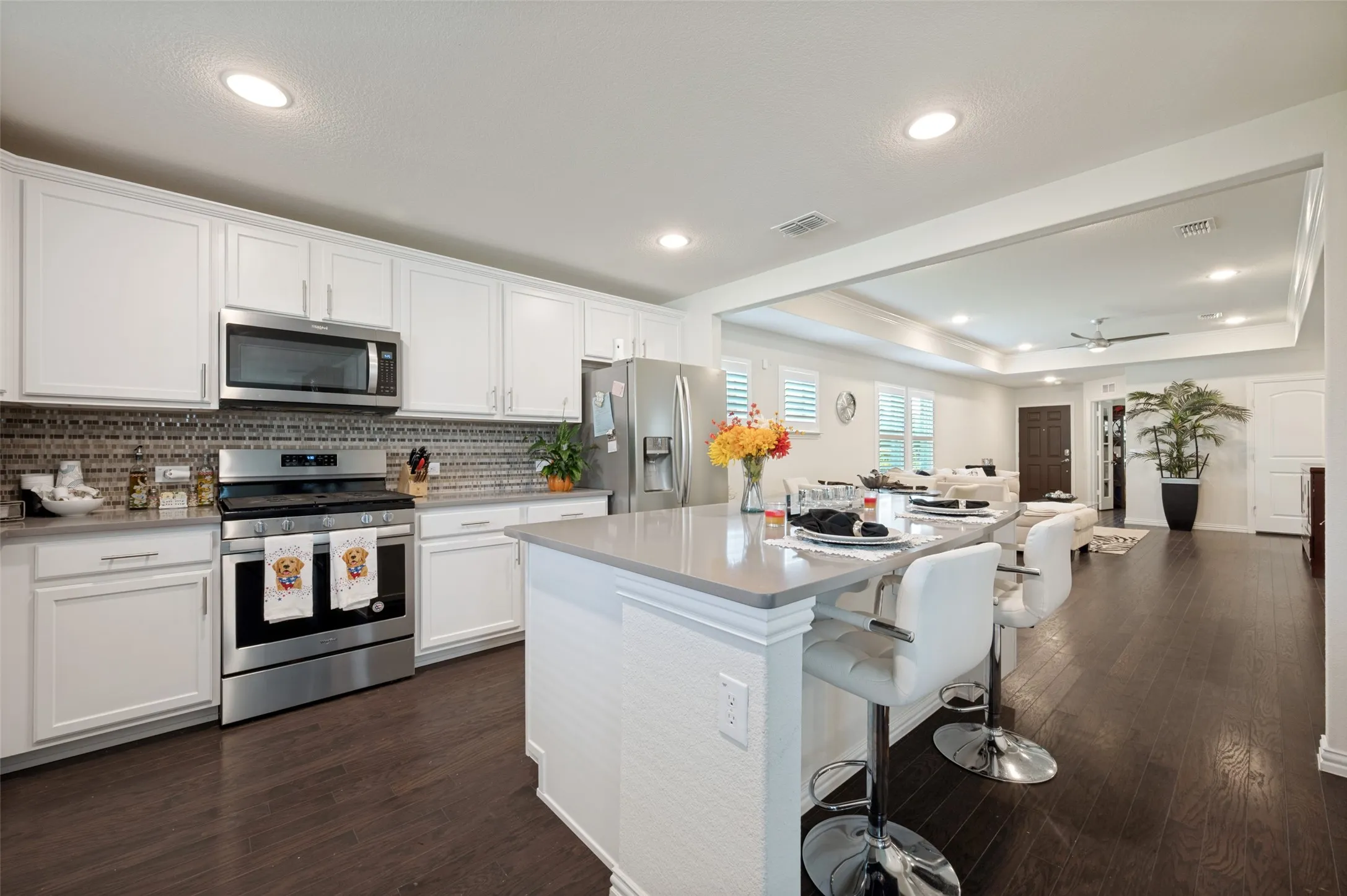 Kitchen featuring white cabinetry, a light gray countertop, and a tiled backsplash