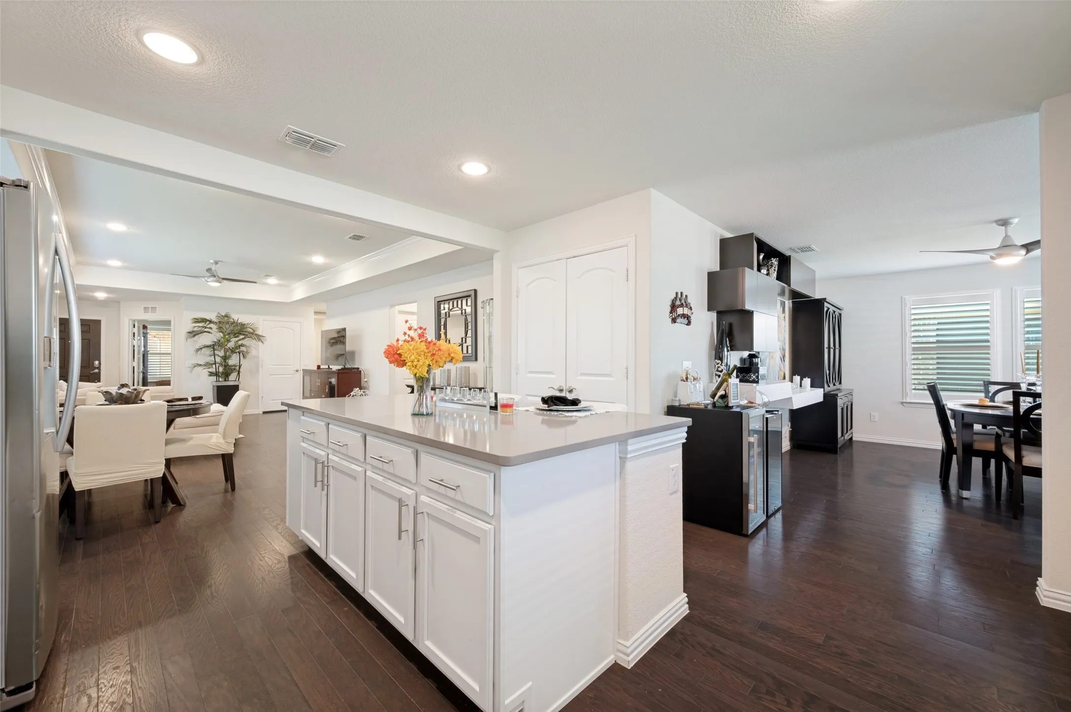 Kitchen island featuring white cabinetry and a light-toned countertop