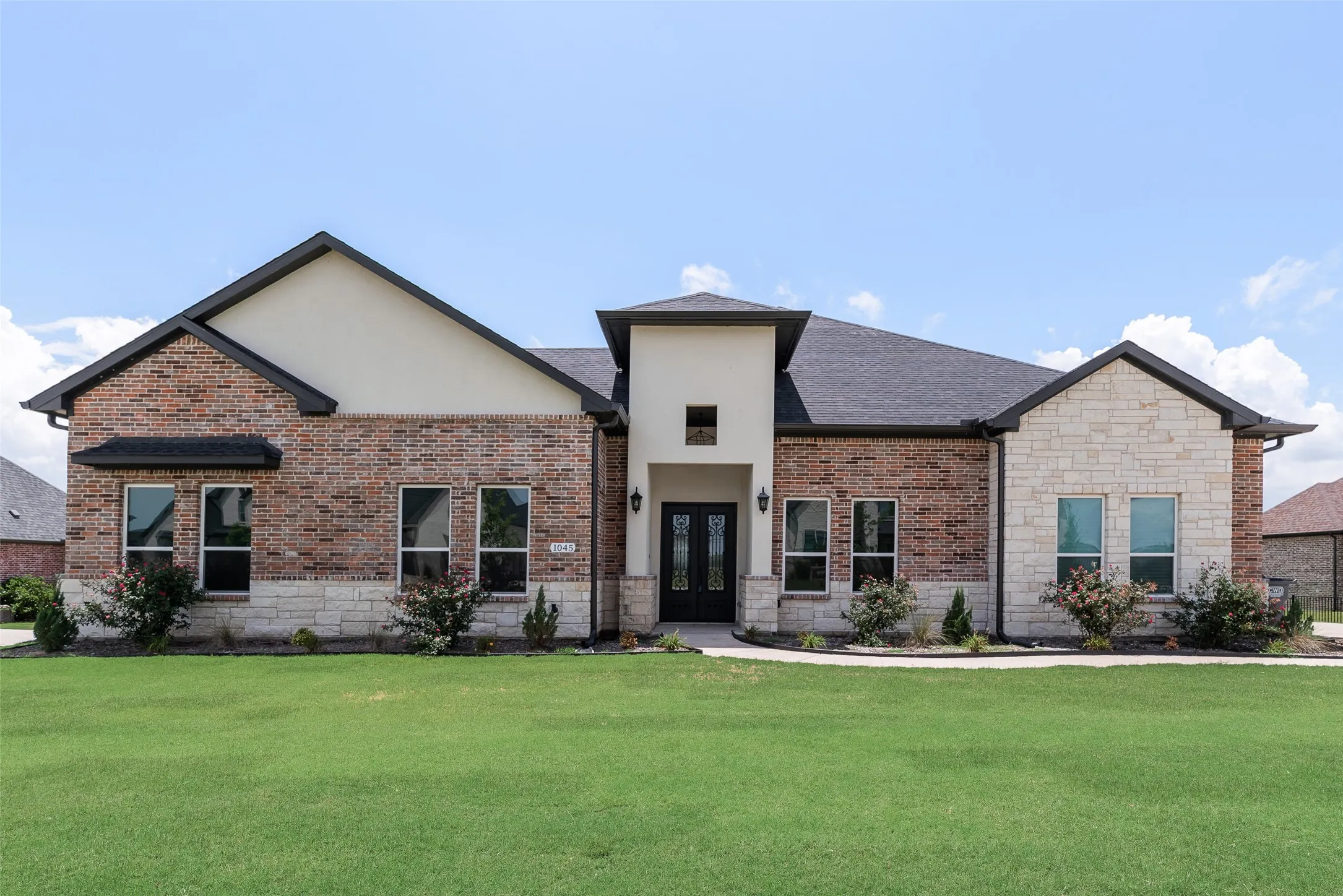Brick and stone veneer exterior with a prominent entry tower