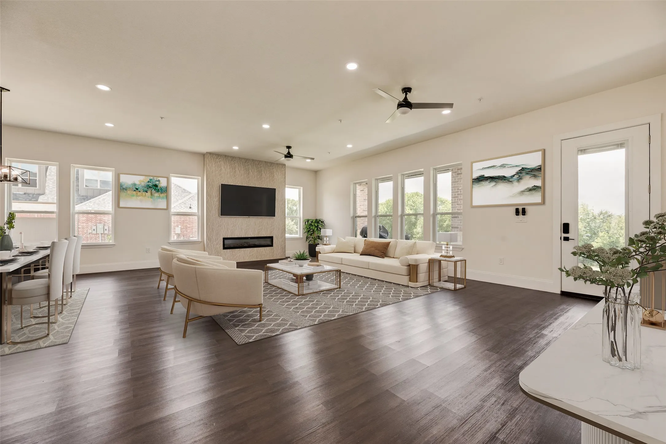 Spacious living area featuring wood-finish flooring, recessed lighting, and multiple windows