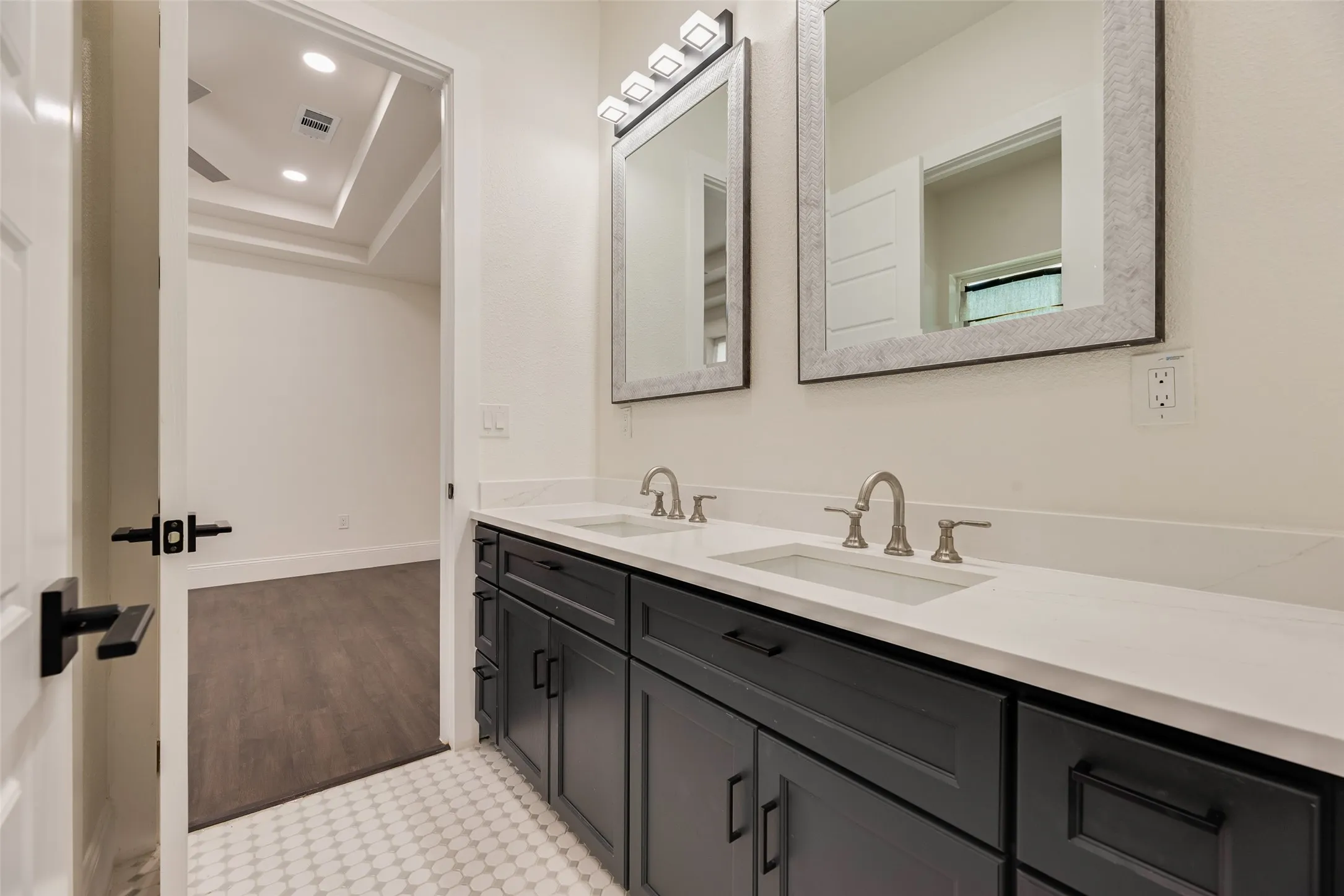 Dual vanity with integrated sinks, white countertop, and brushed nickel faucets