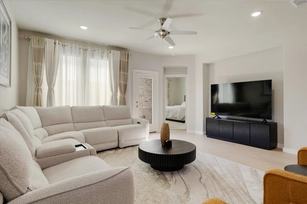 Recessed lighting, light wood-finish flooring, ceiling fan, and wall niche for media