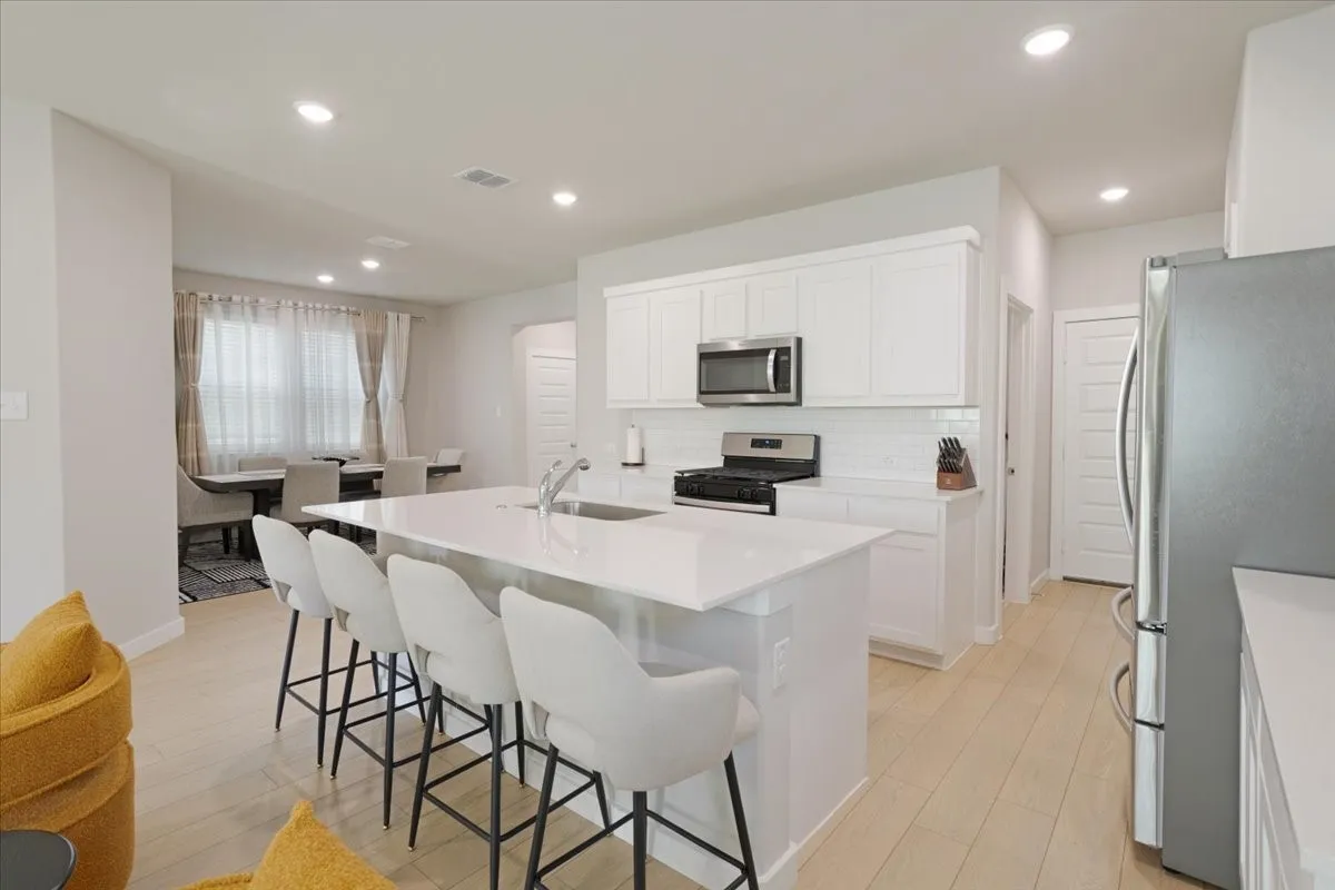 White cabinetry with stainless steel appliances