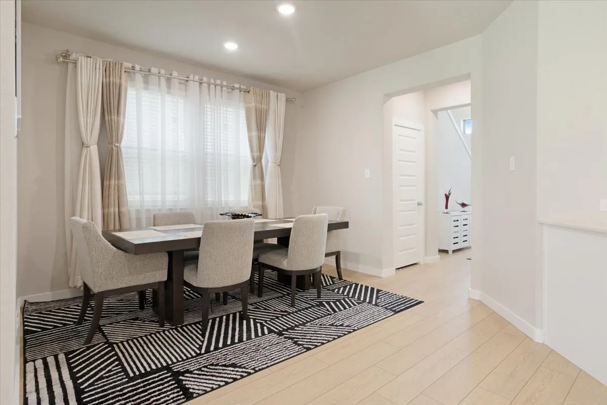 Recessed lighting, light wood-finish flooring, and white interior doors