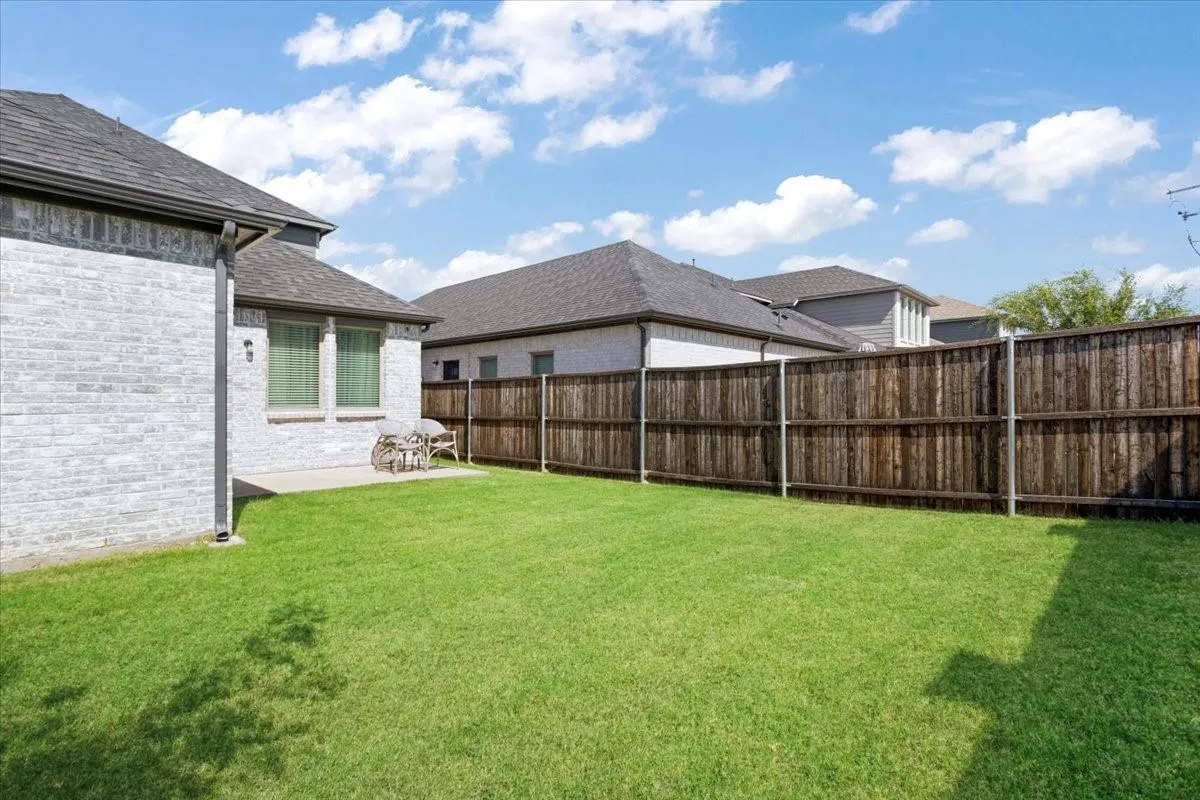 Expansive lawn area with a privacy fence