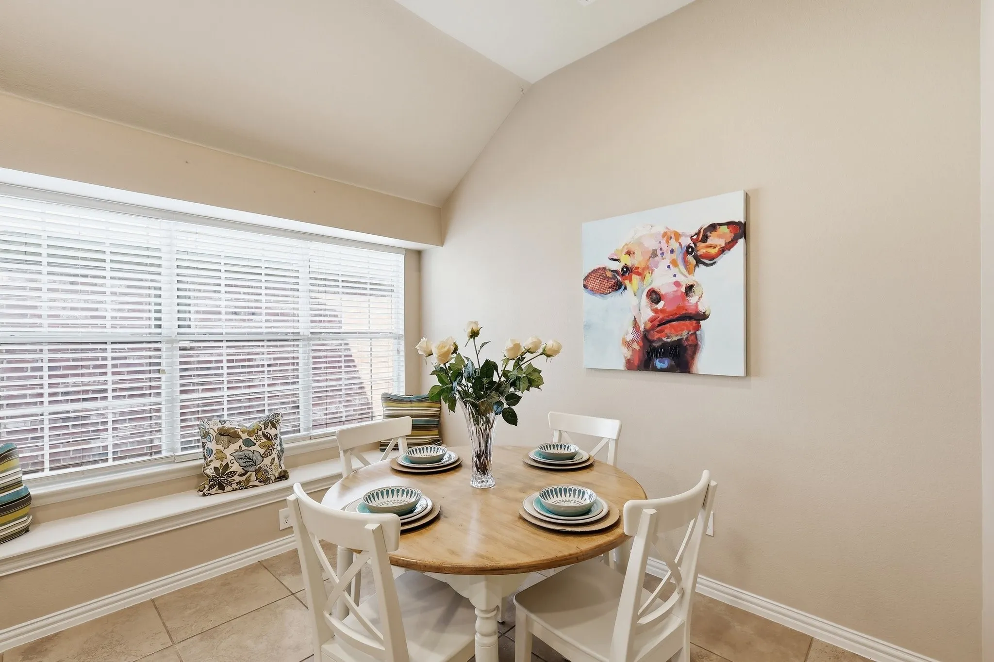 Recessed window well with sill, vaulted ceiling, and tiled flooring