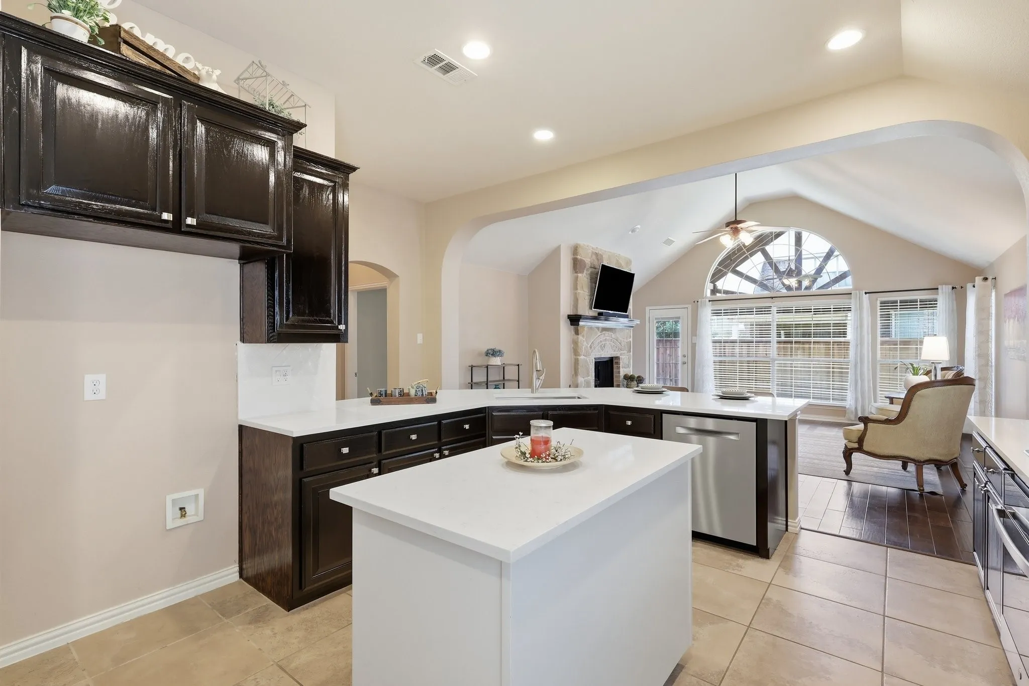 Kitchen featuring an island, dark cabinetry, and light countertops