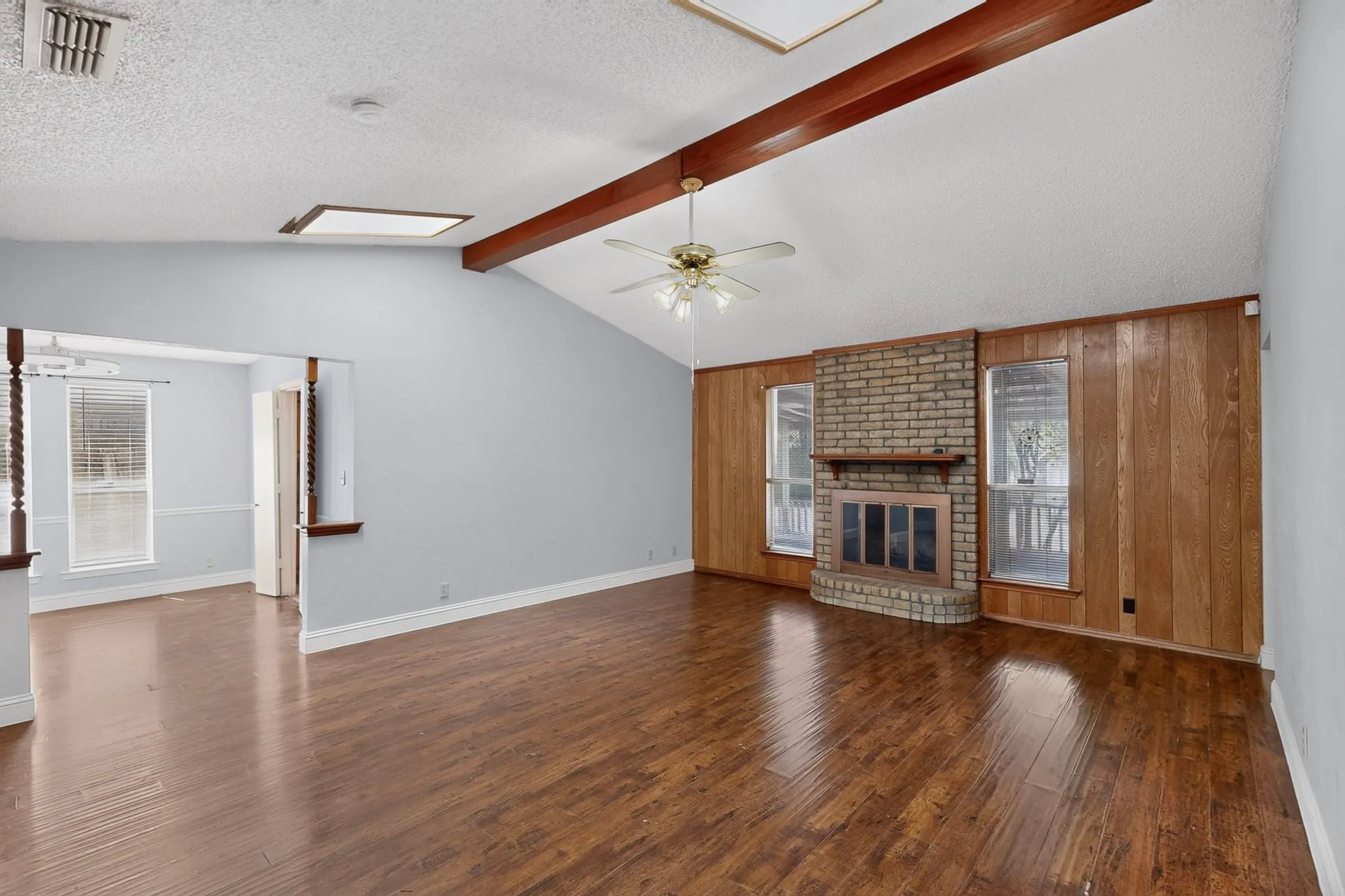 Vaulted ceiling with exposed wood beams and skylights