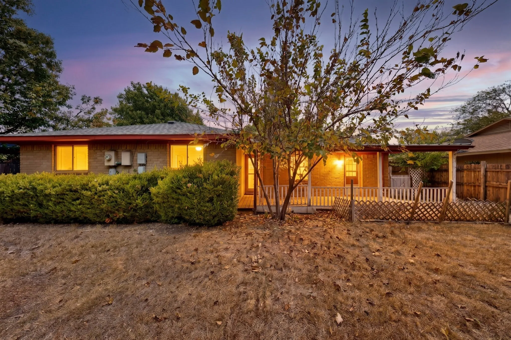 AI Brick exterior, covered patio, fenced yard, mature landscaping, and an established tree