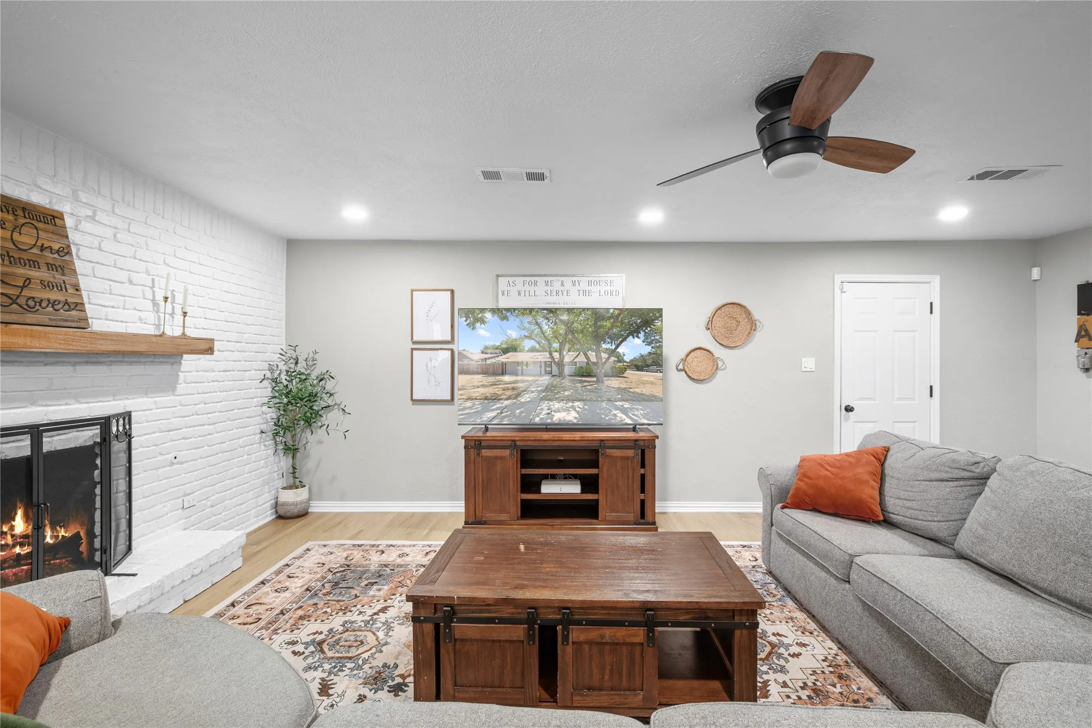 Painted brick fireplace with a wood-mantel shelf
